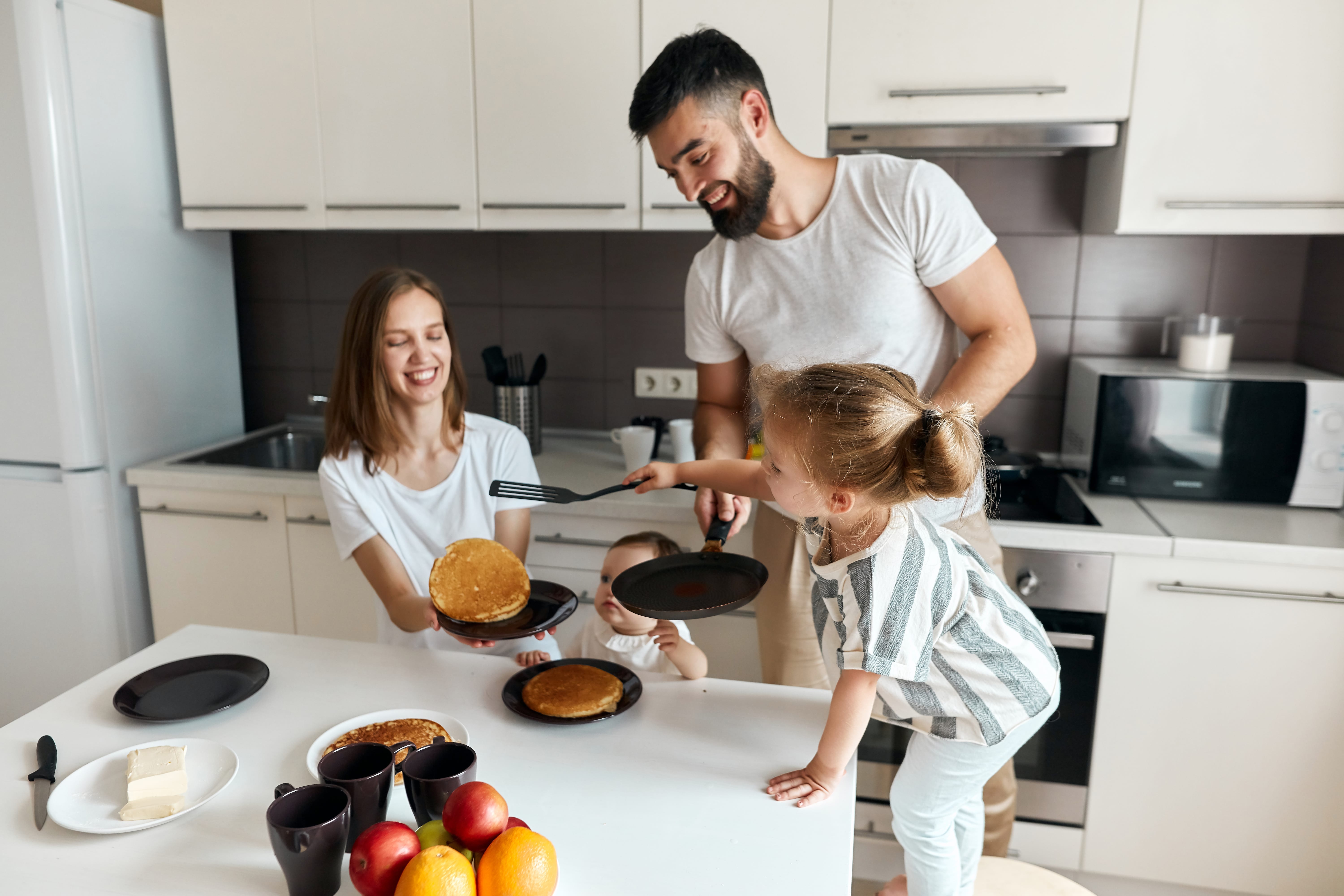 Family making breakfast in kitchenette