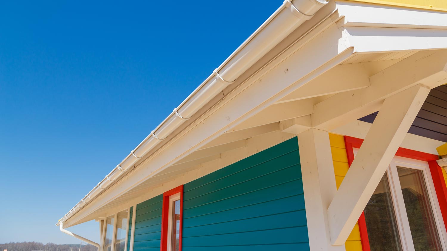 A colorful house with regular rain gutters