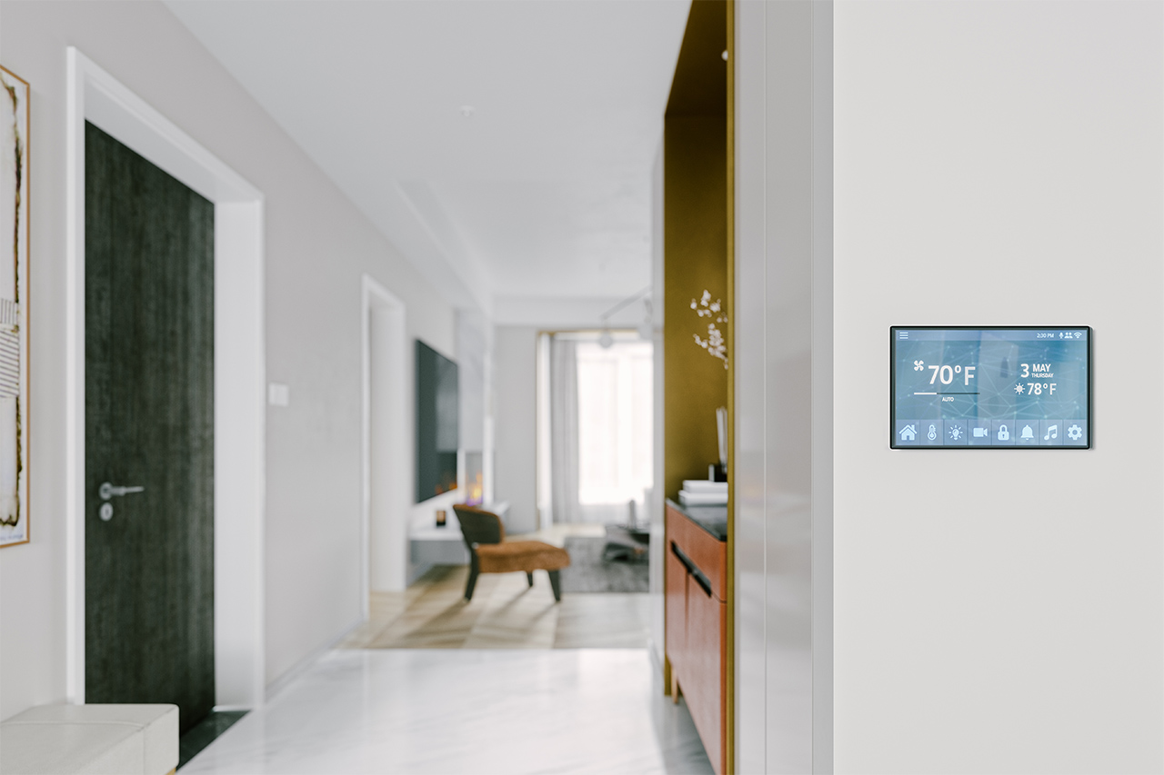 digital smart thermostat on wall at home