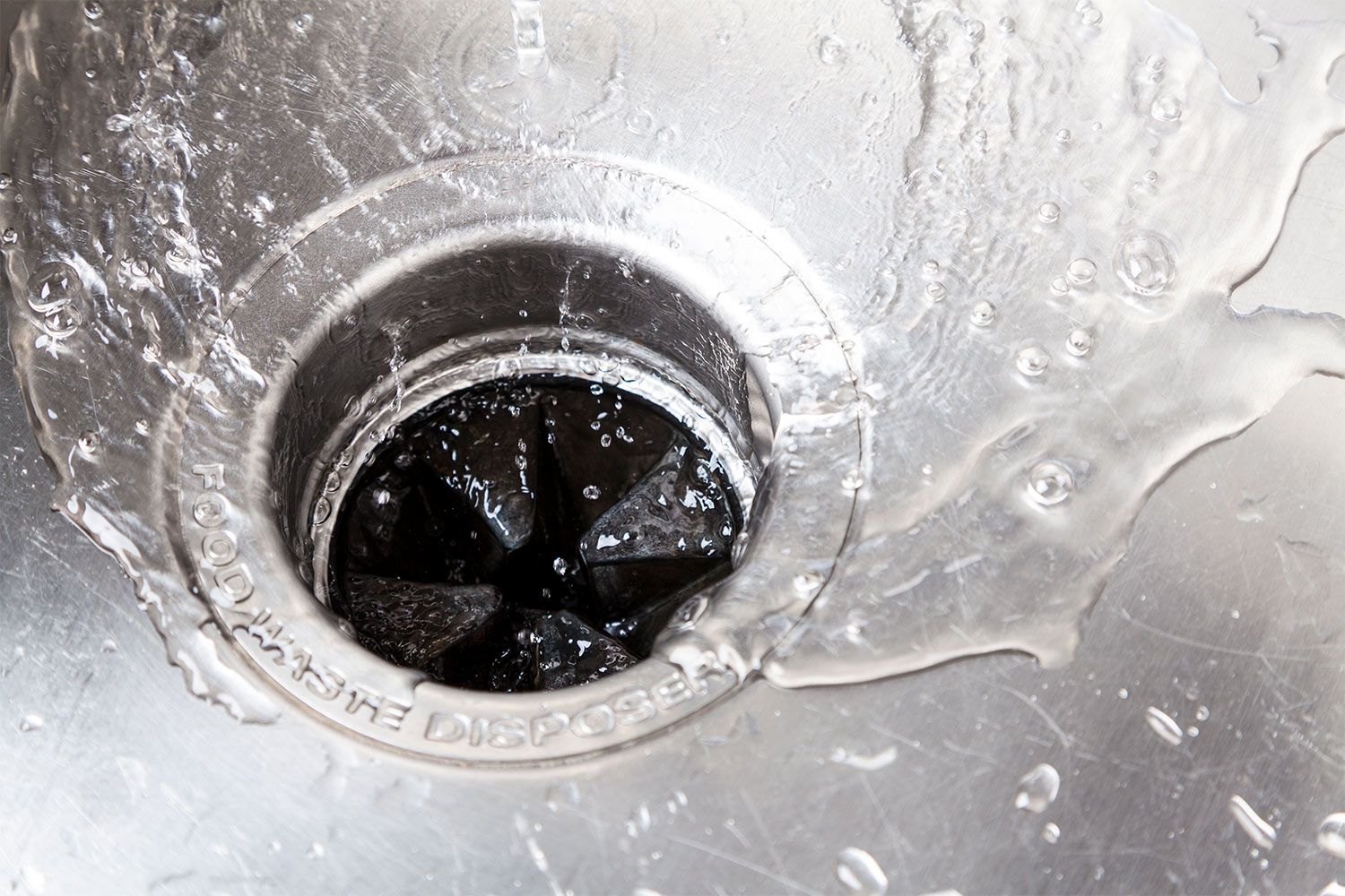 close up on water going down garbage disposal