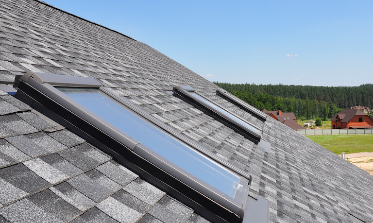 three skylight windows on the roof of a house