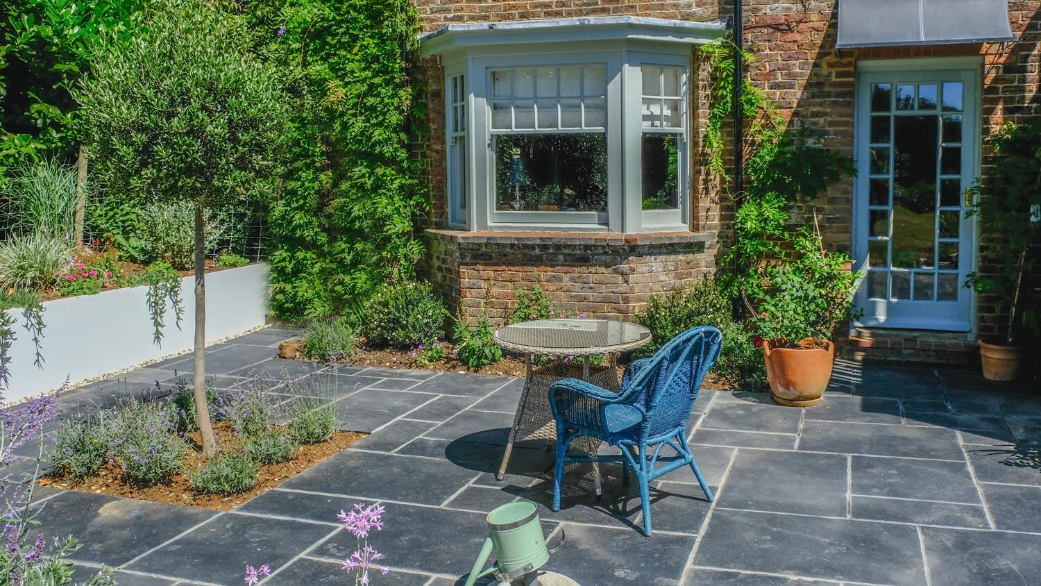 A table and a chair on a concrete patio with stamped overlay