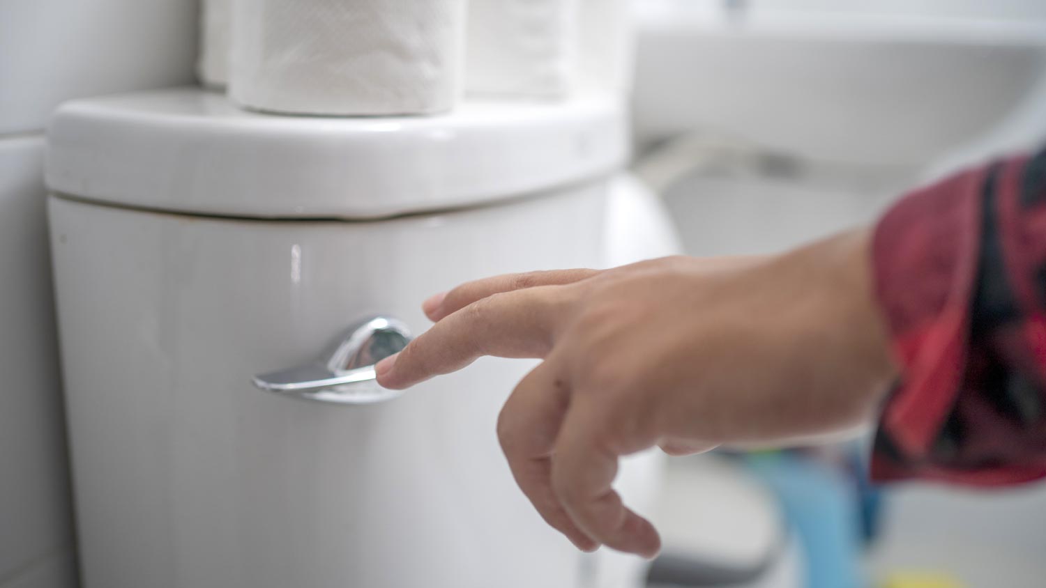 A man flushing toilet