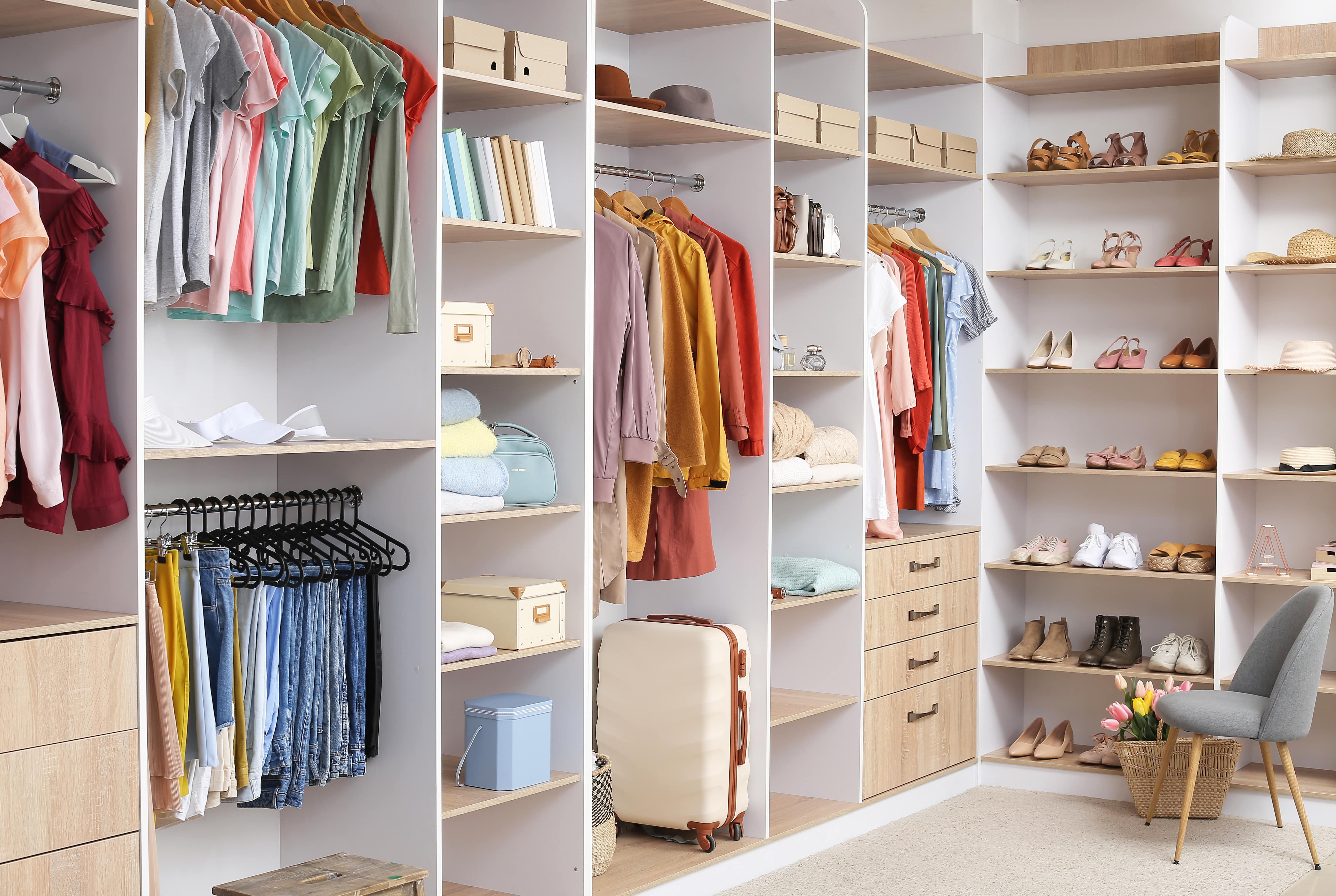 A clean and organized walk-in closet with built-in organizer