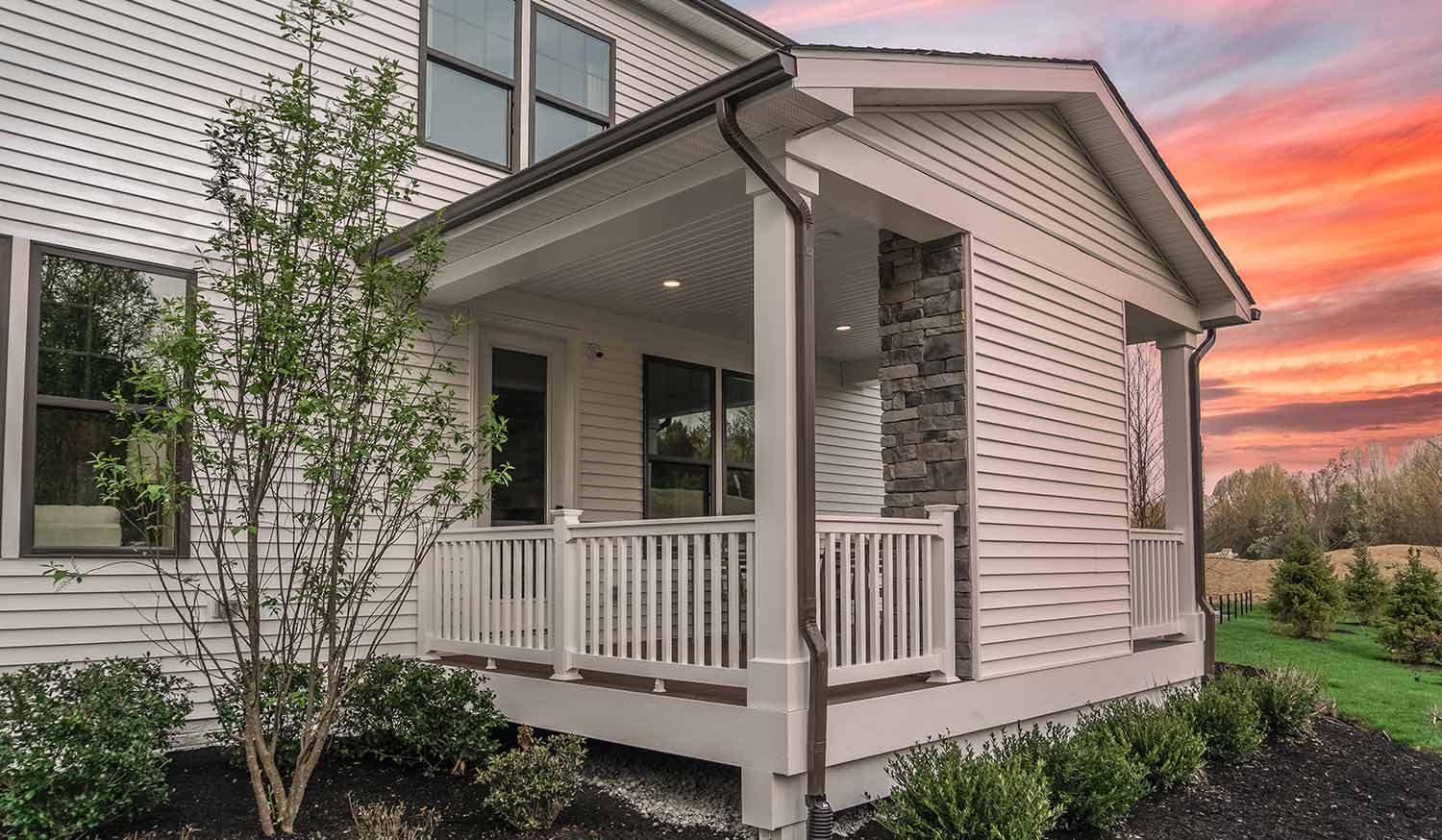 Brown gutters on white porch siding