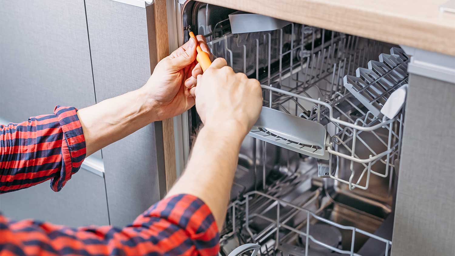 Man repairing dishwasher