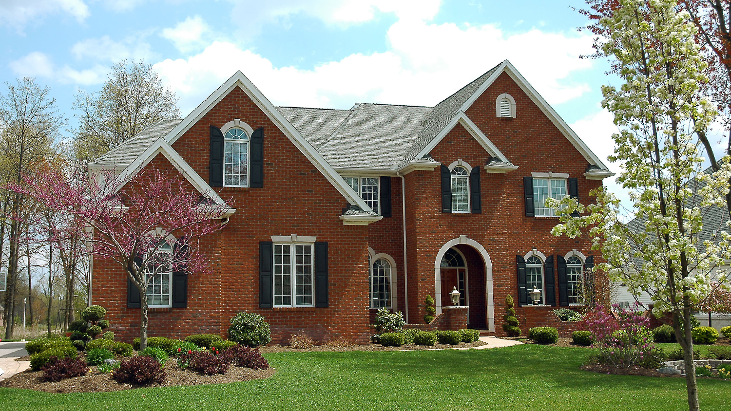 brick house with shutters on windows