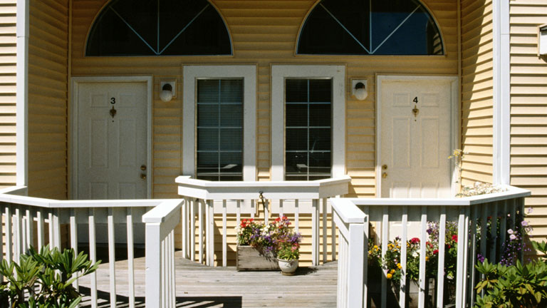 exterior front porch of duplex home, two doors