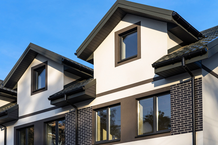 townhouse with black roof and black gutters