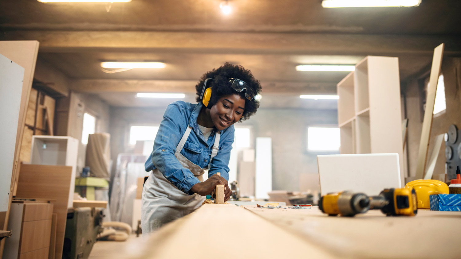 A woman working as a carpenter in her workshop