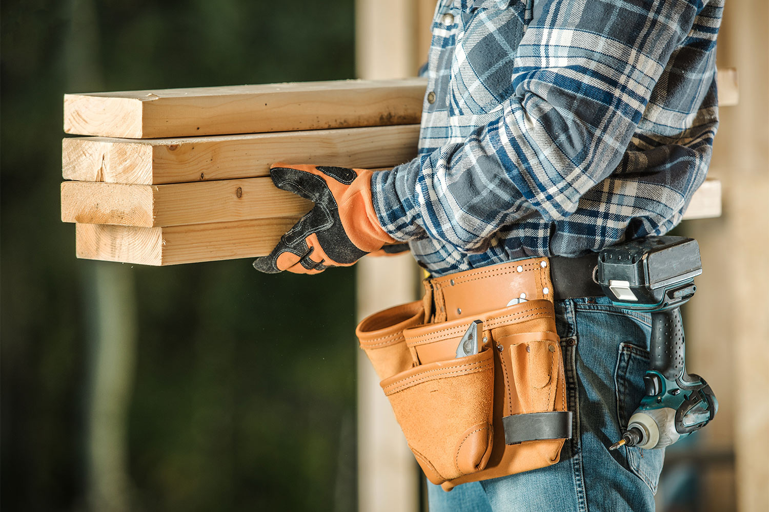 man carrying pieces of wood