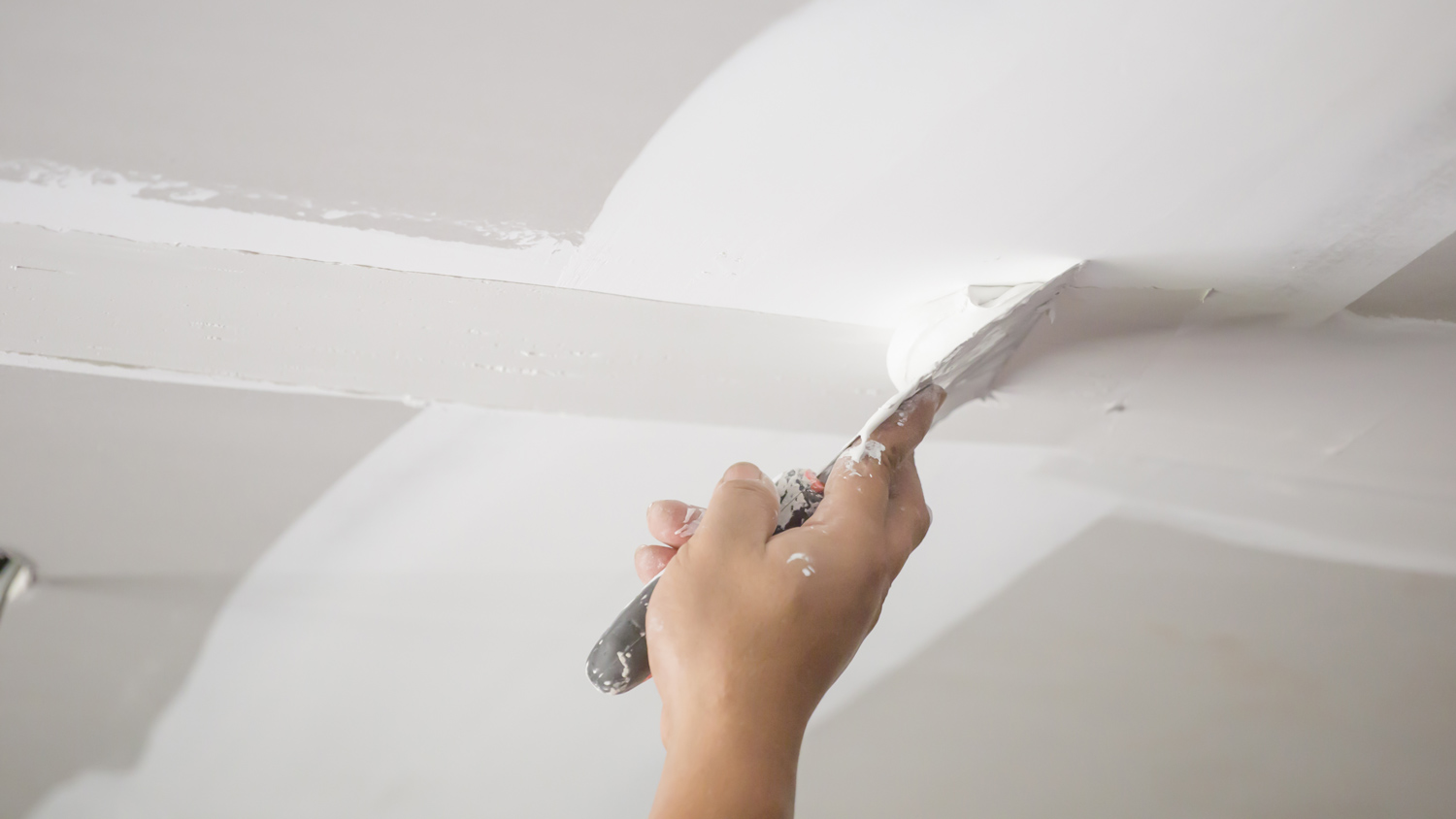 A man repairing a drywall damage