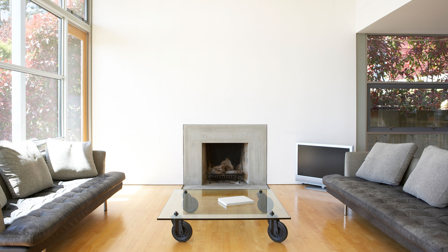 A lounge area with a contemporary concrete fireplace insert