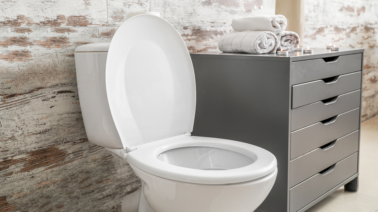Toilet with lifted lid in stylish bathroom