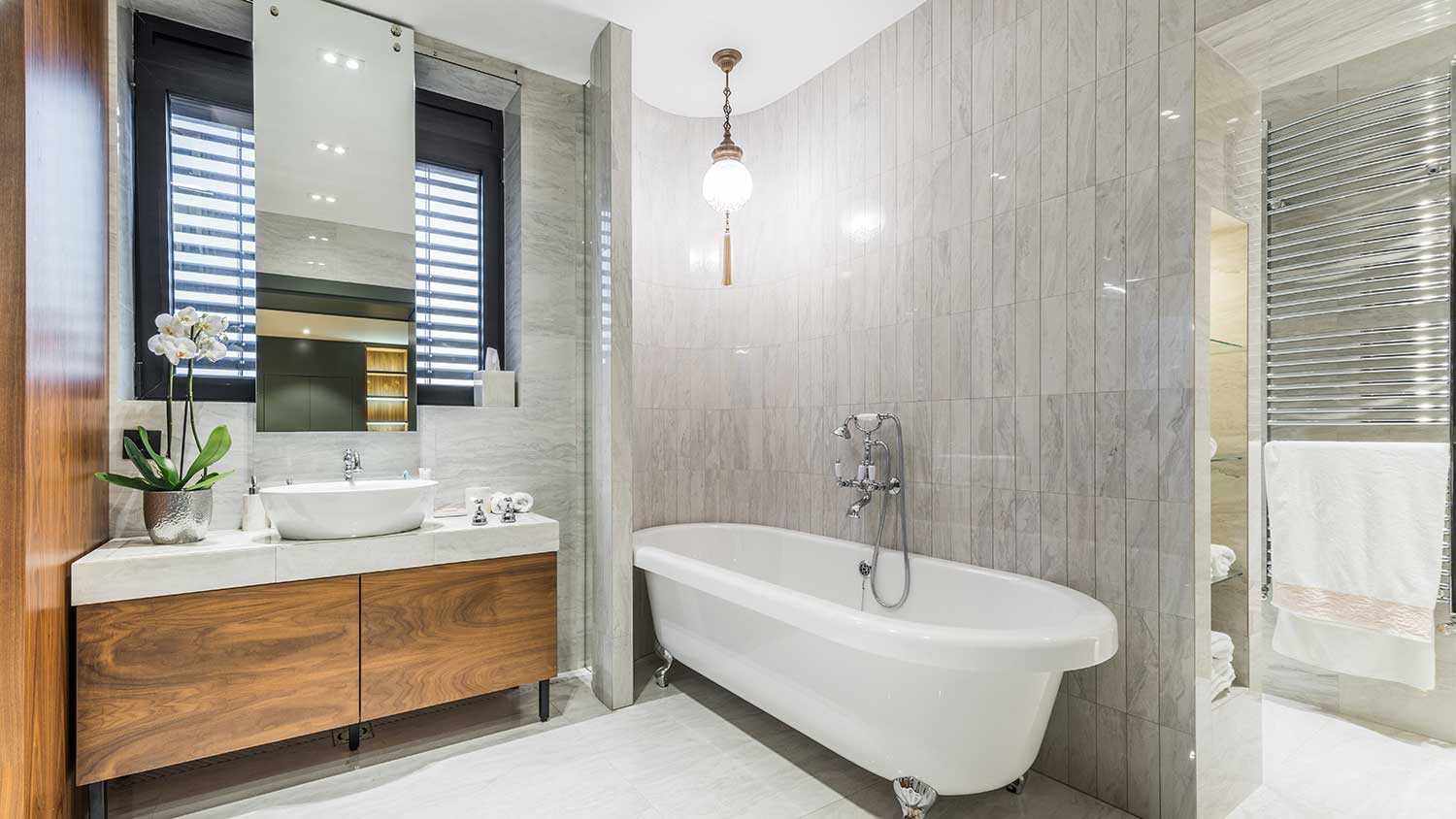 Bathroom with chandelier over bathtub