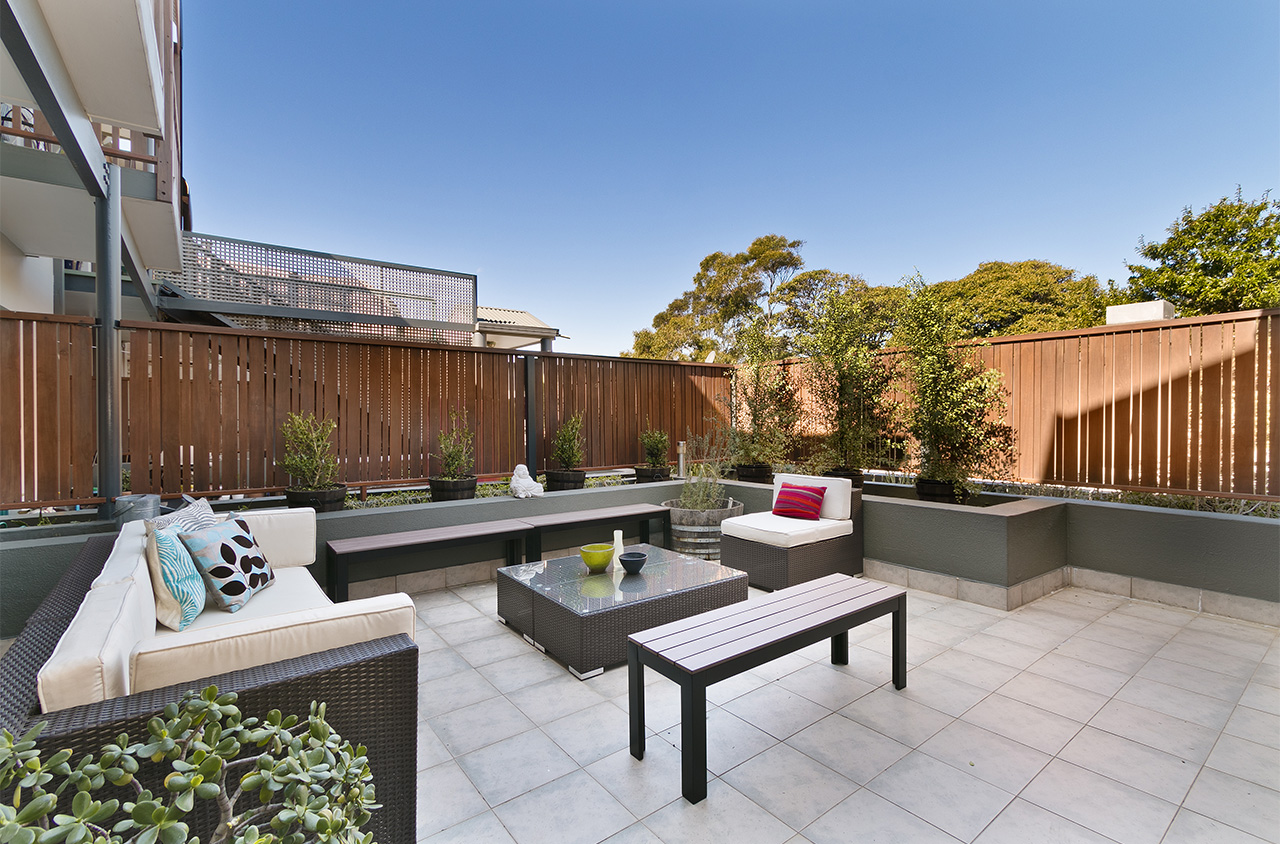 large patio space with wooden fence