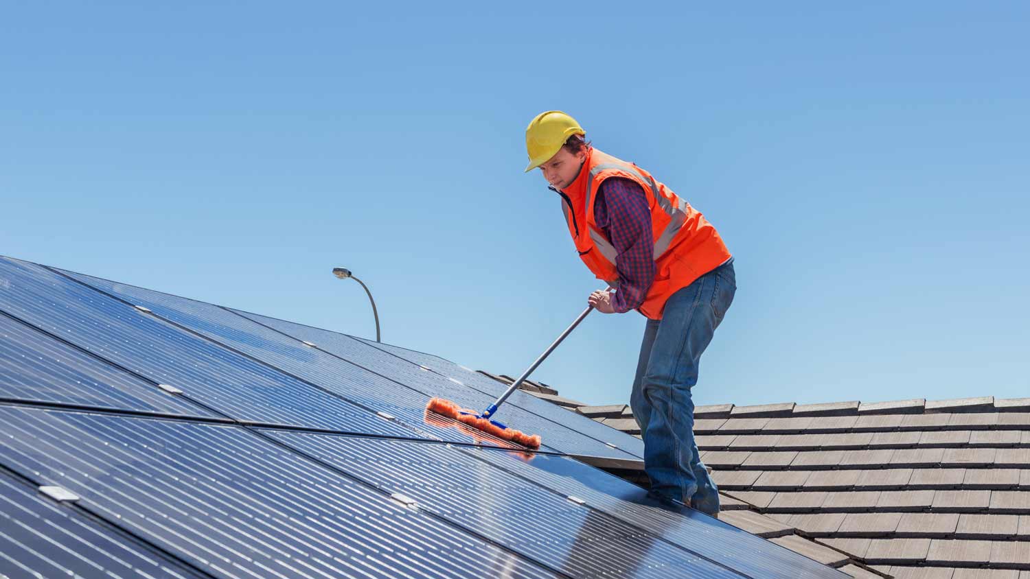 worker doing solar panel maintenance