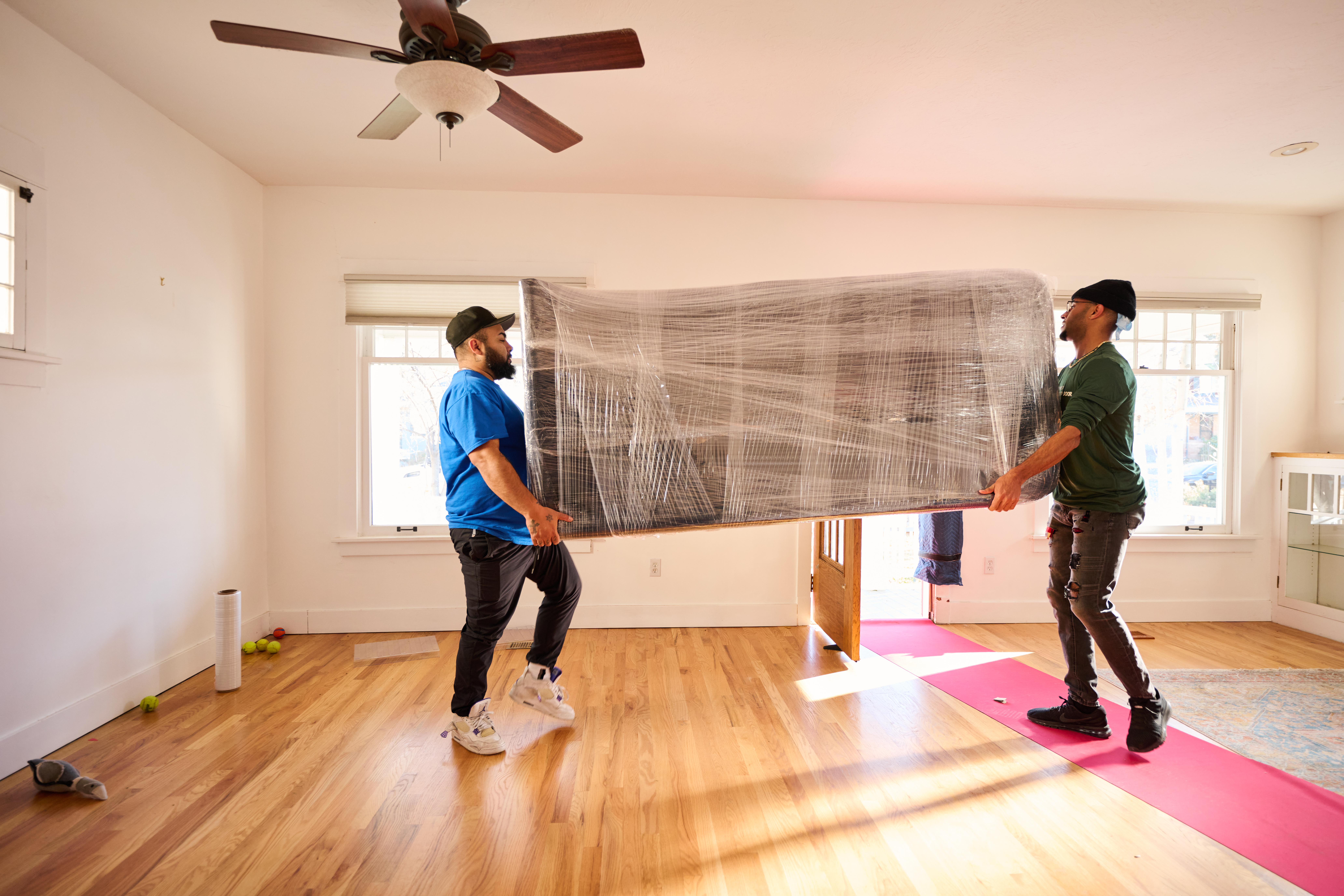 Men moving large piece of furniture.