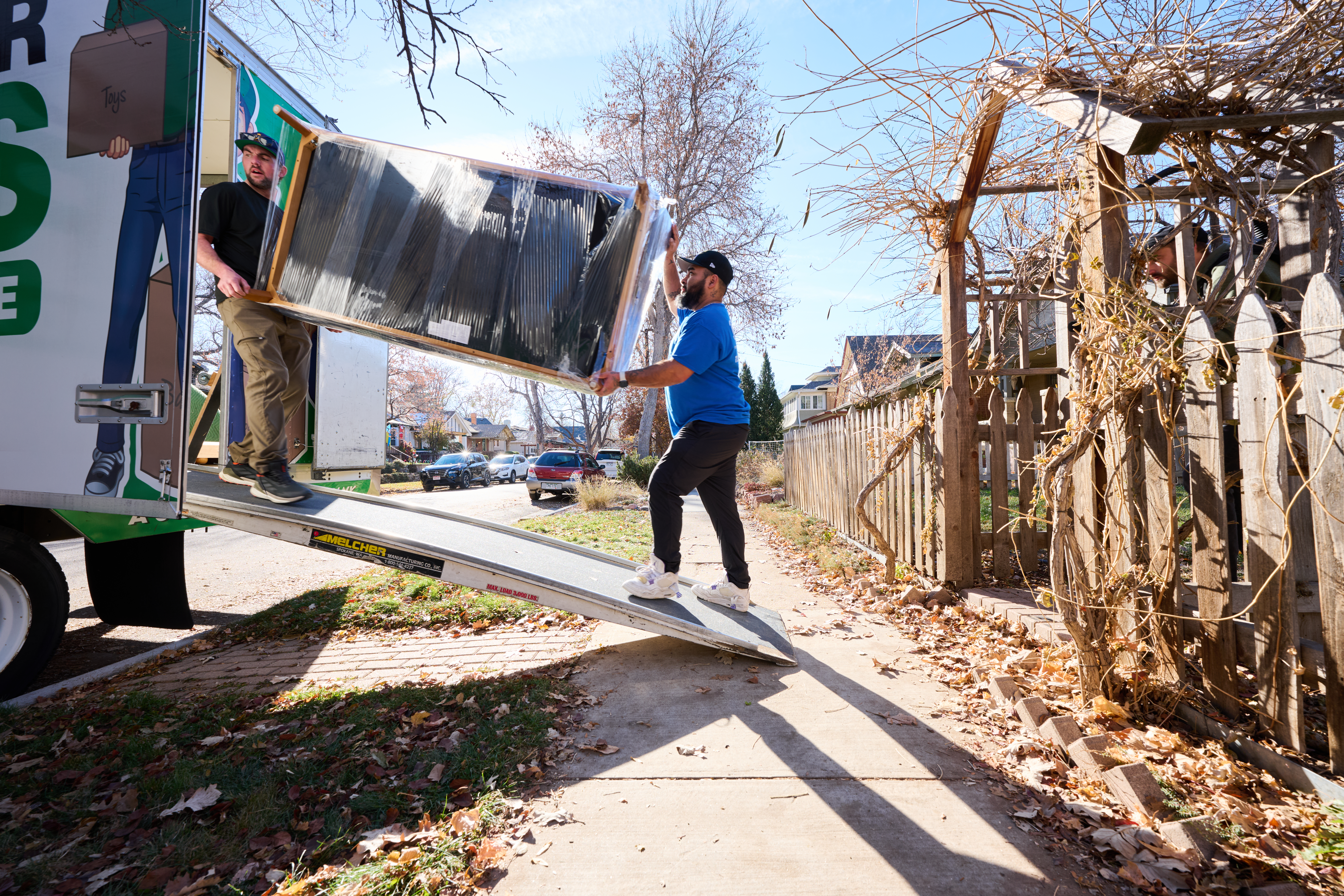 Men loading furniture into a moving truck.