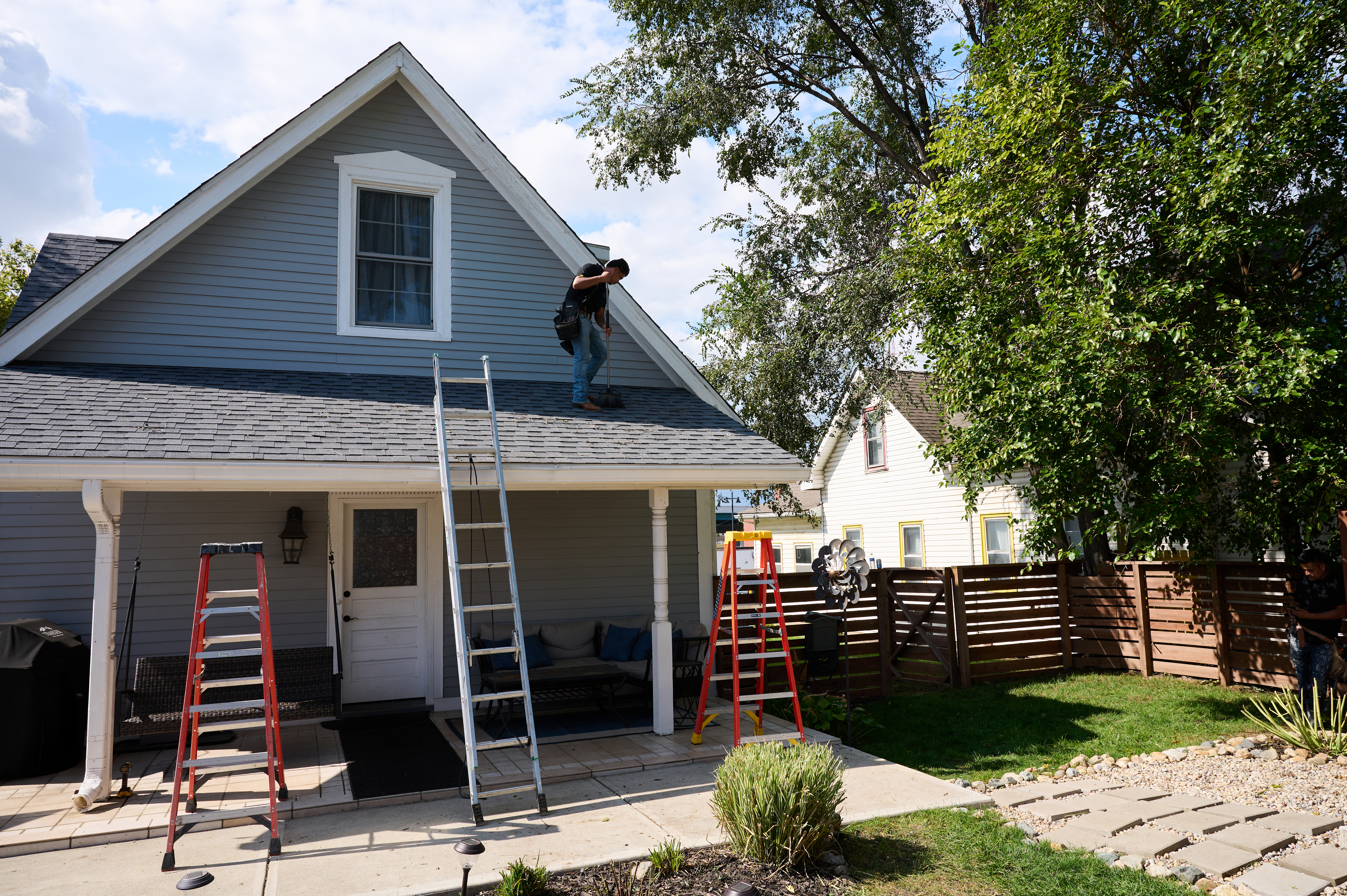 Man finishing up work on roof.