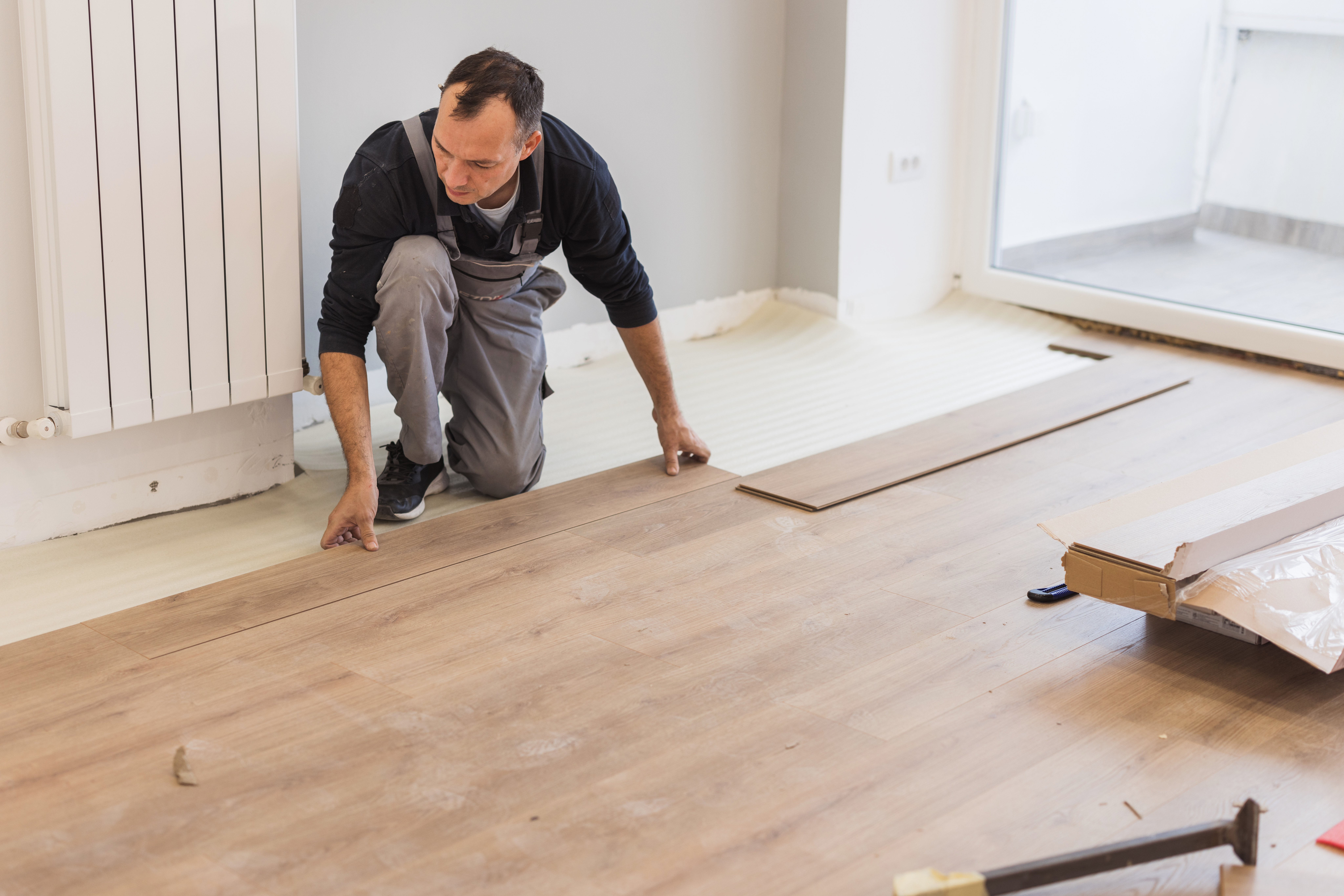 Carpenter adjusting hardwood floor