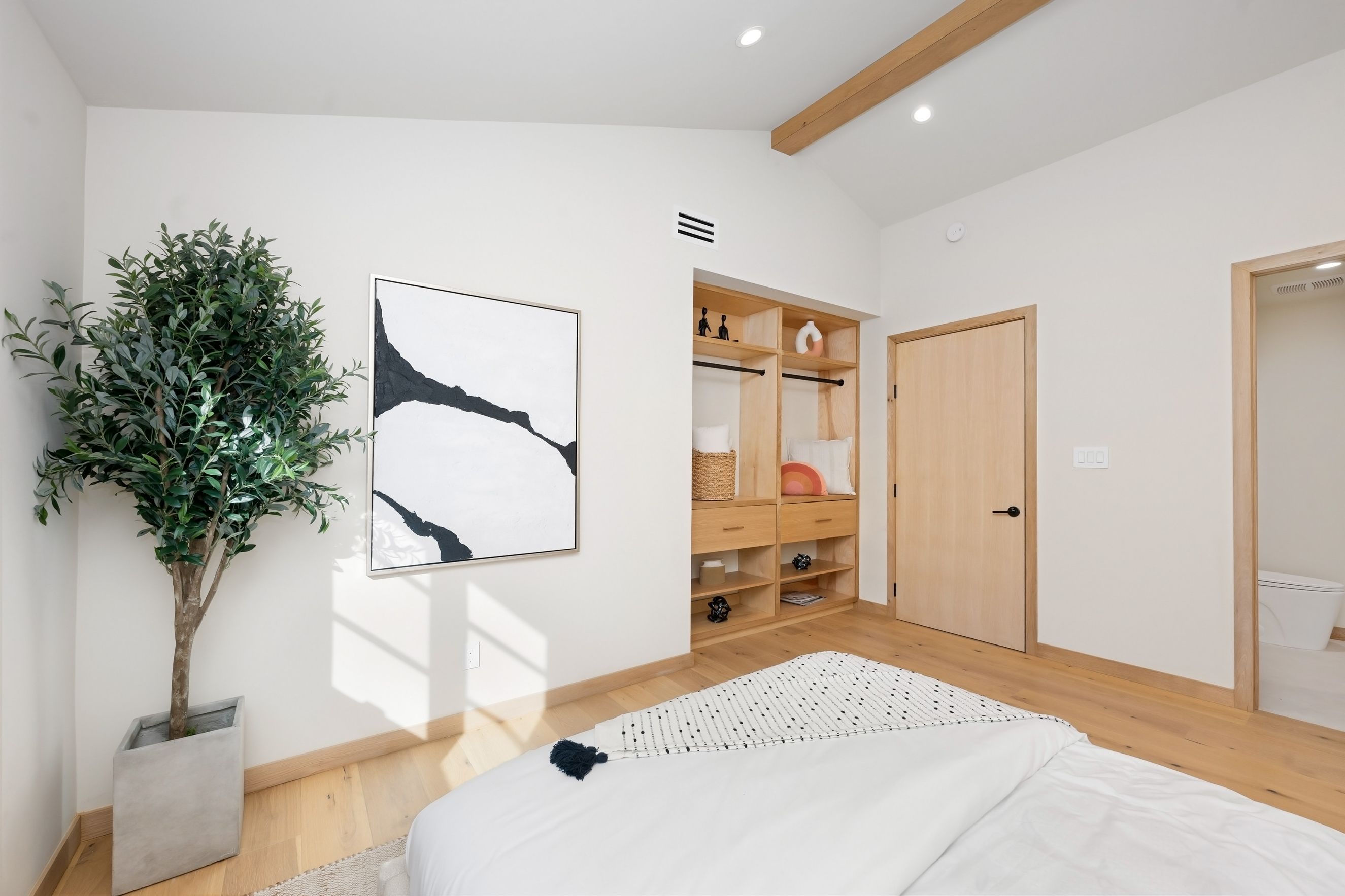 Scandinavian style bedroom with wooden baseboard and white walls