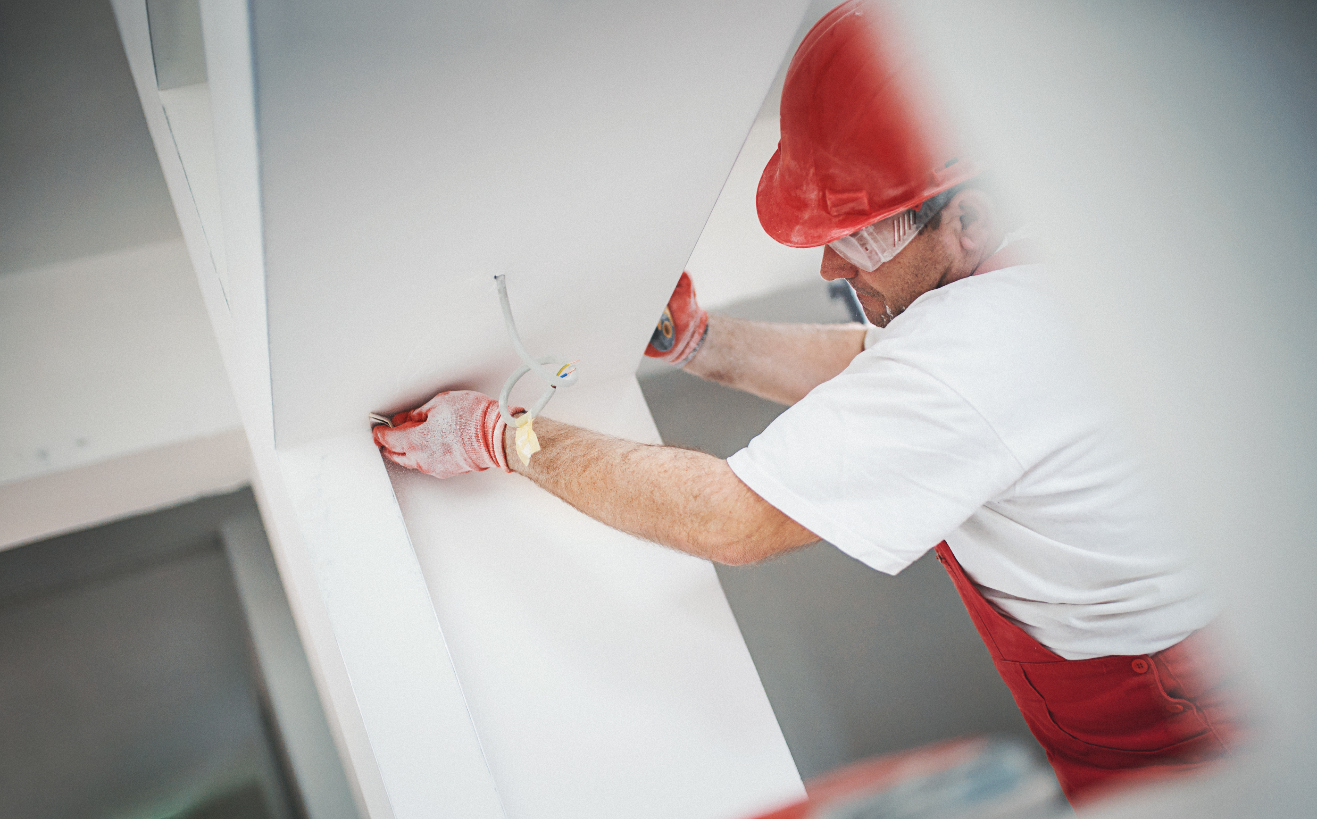 Construction worker finishing a drywall
