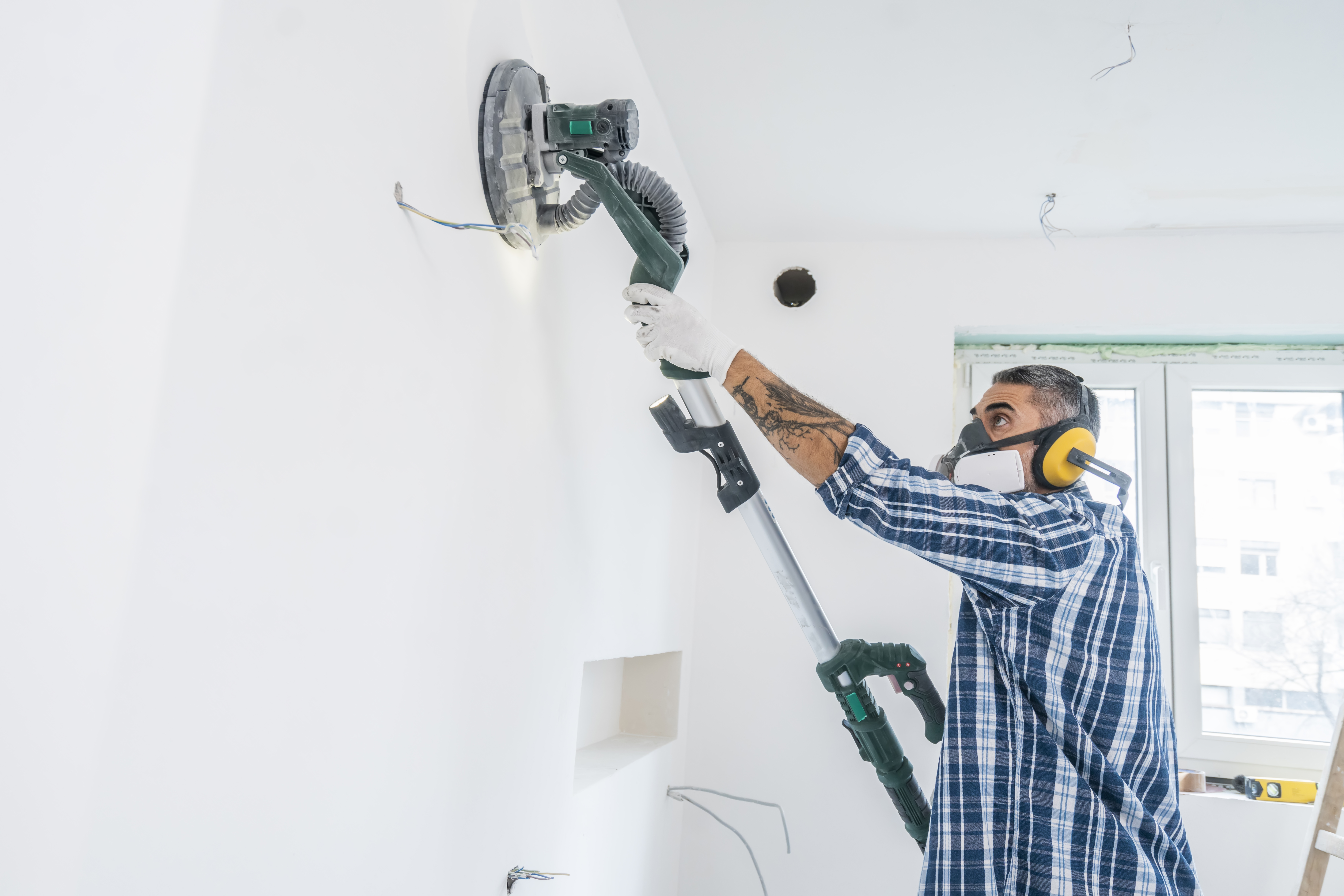 Man using vacuum sanding machine