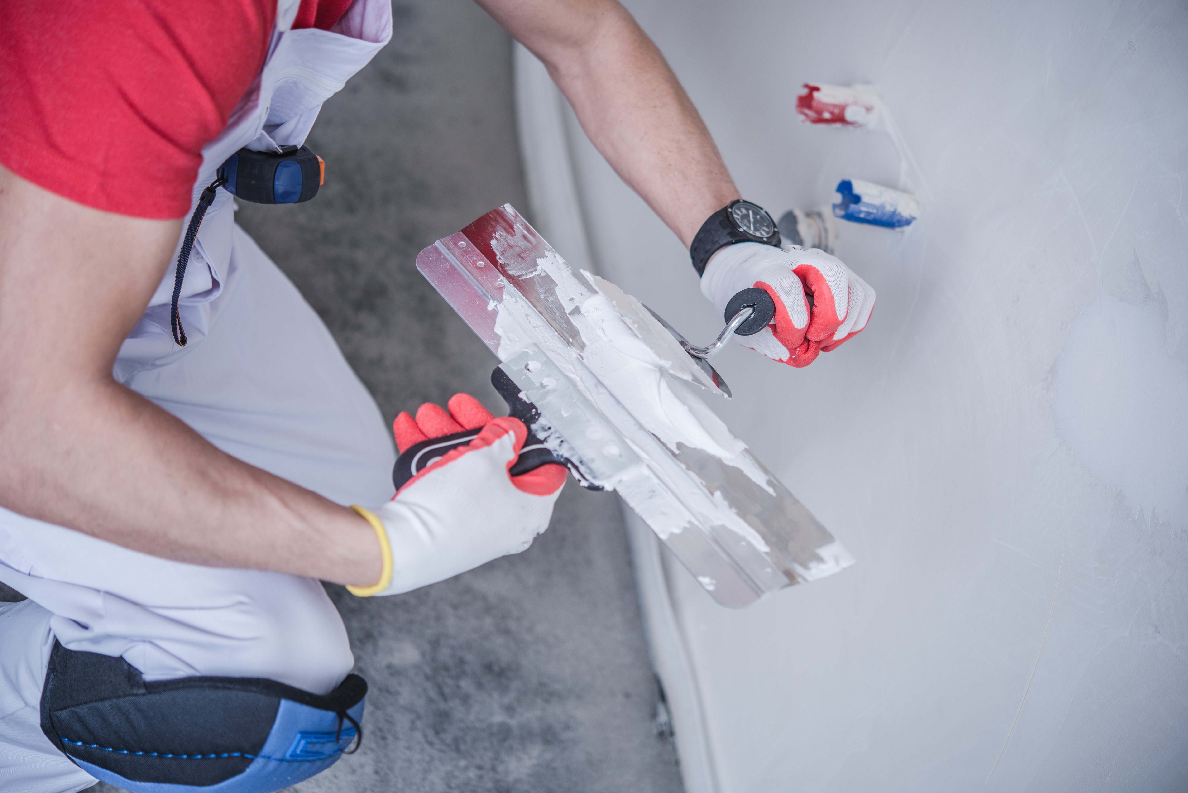 Worker with patching material and tools