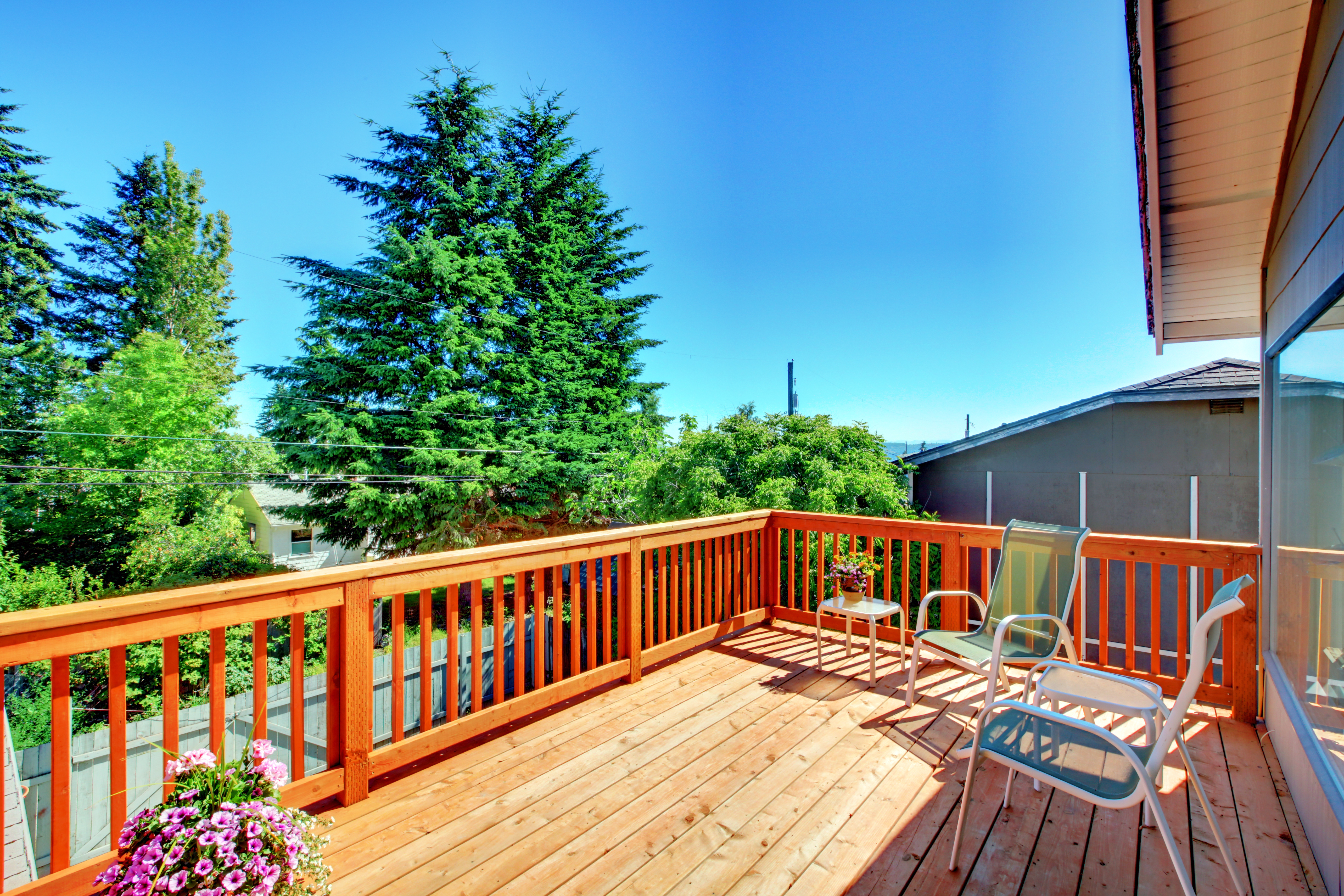 Raised deck with stained wood railing 