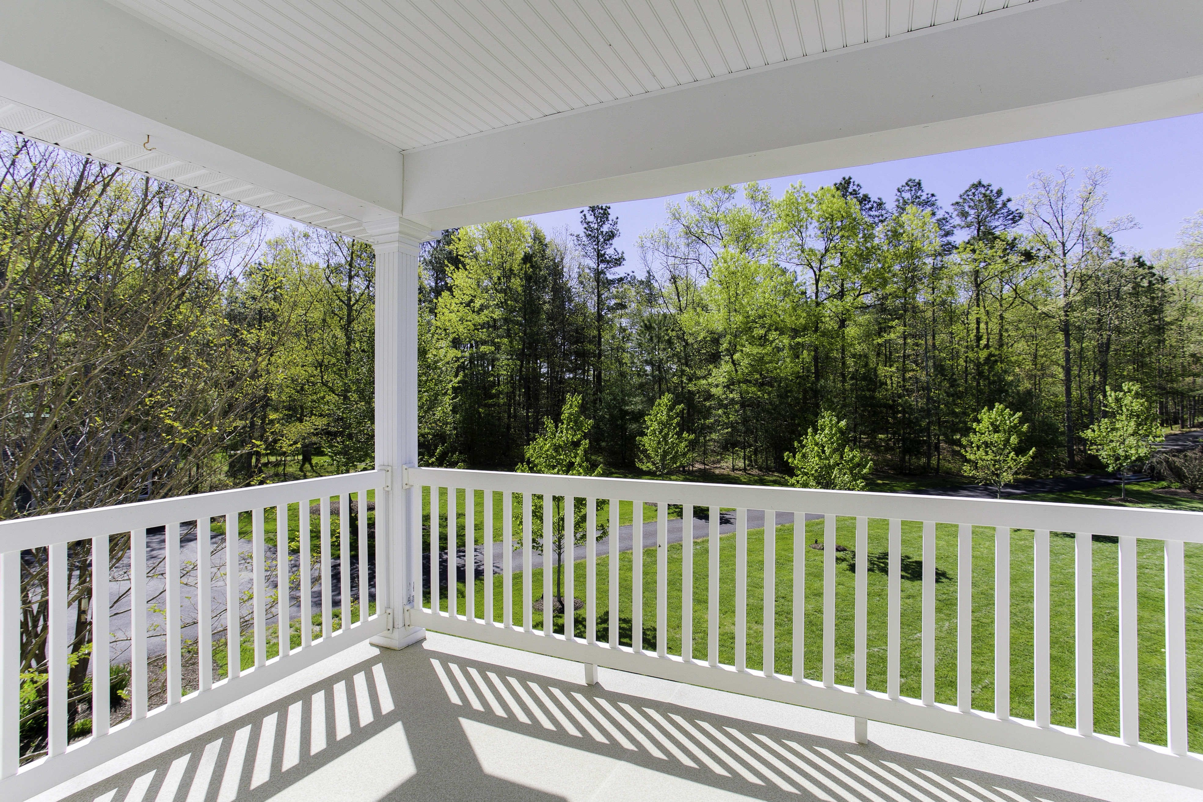 Covered deck with white vinyl railing 