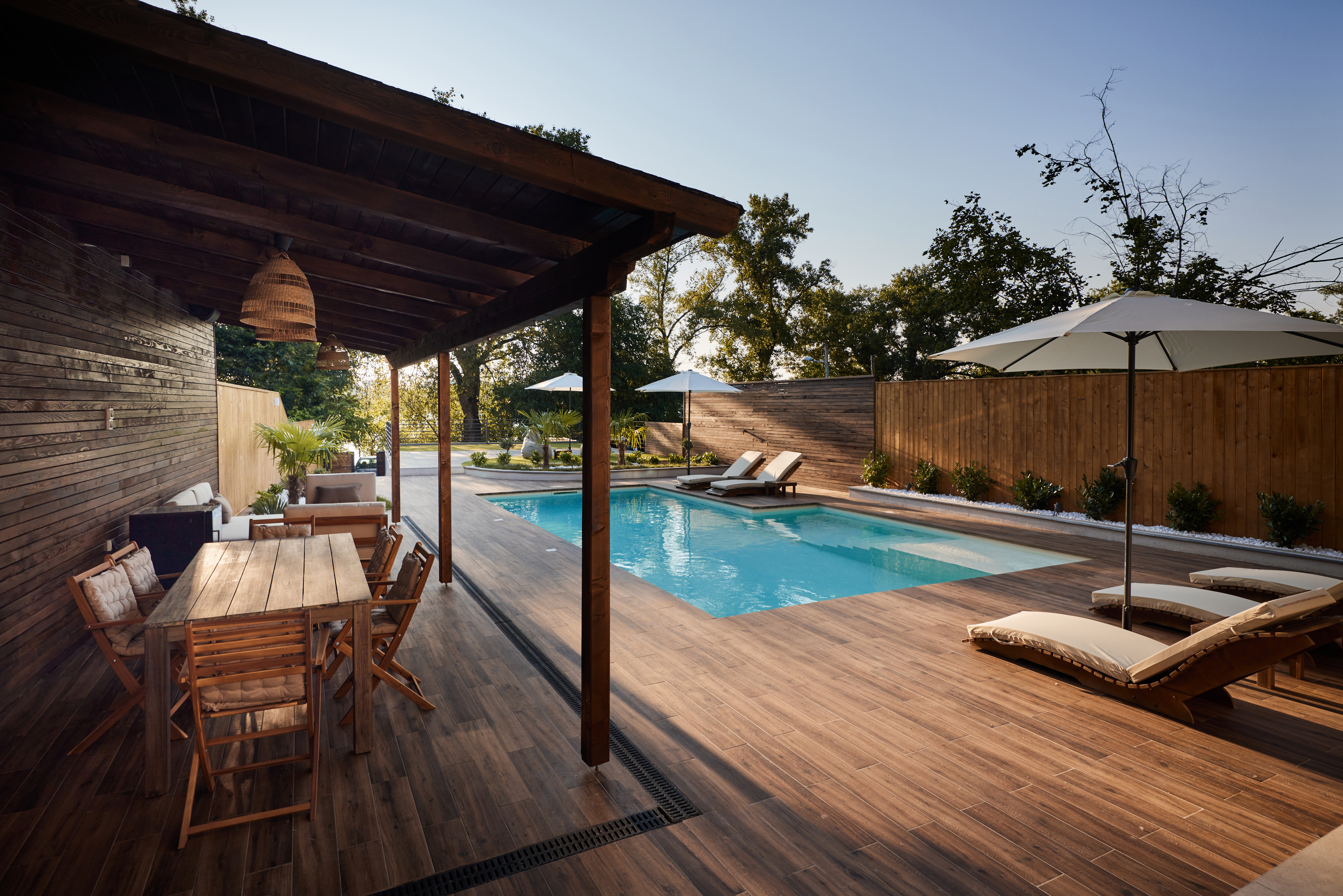 A wooden deck around a swimming pool