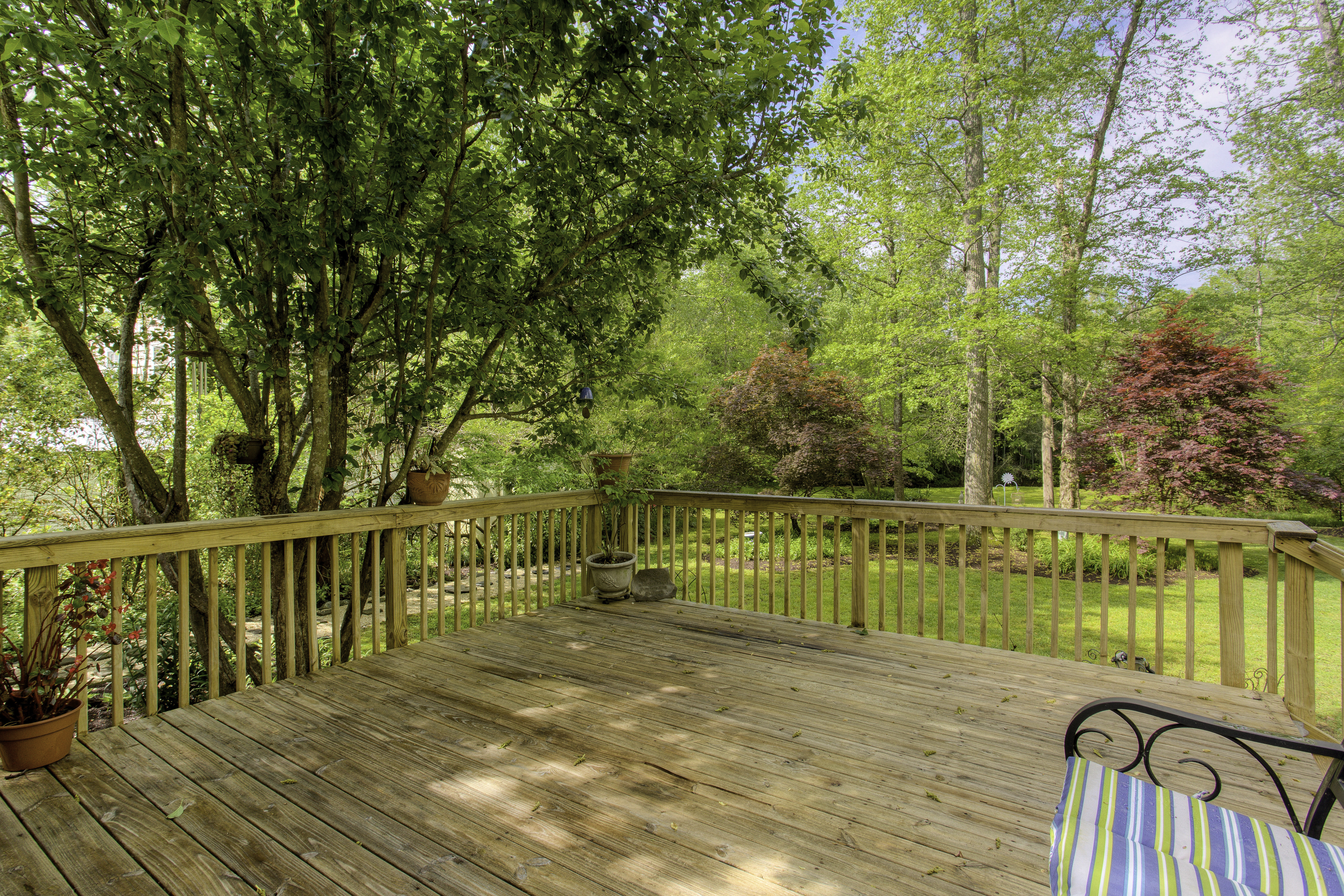 A wooden deck in the backyard during summer