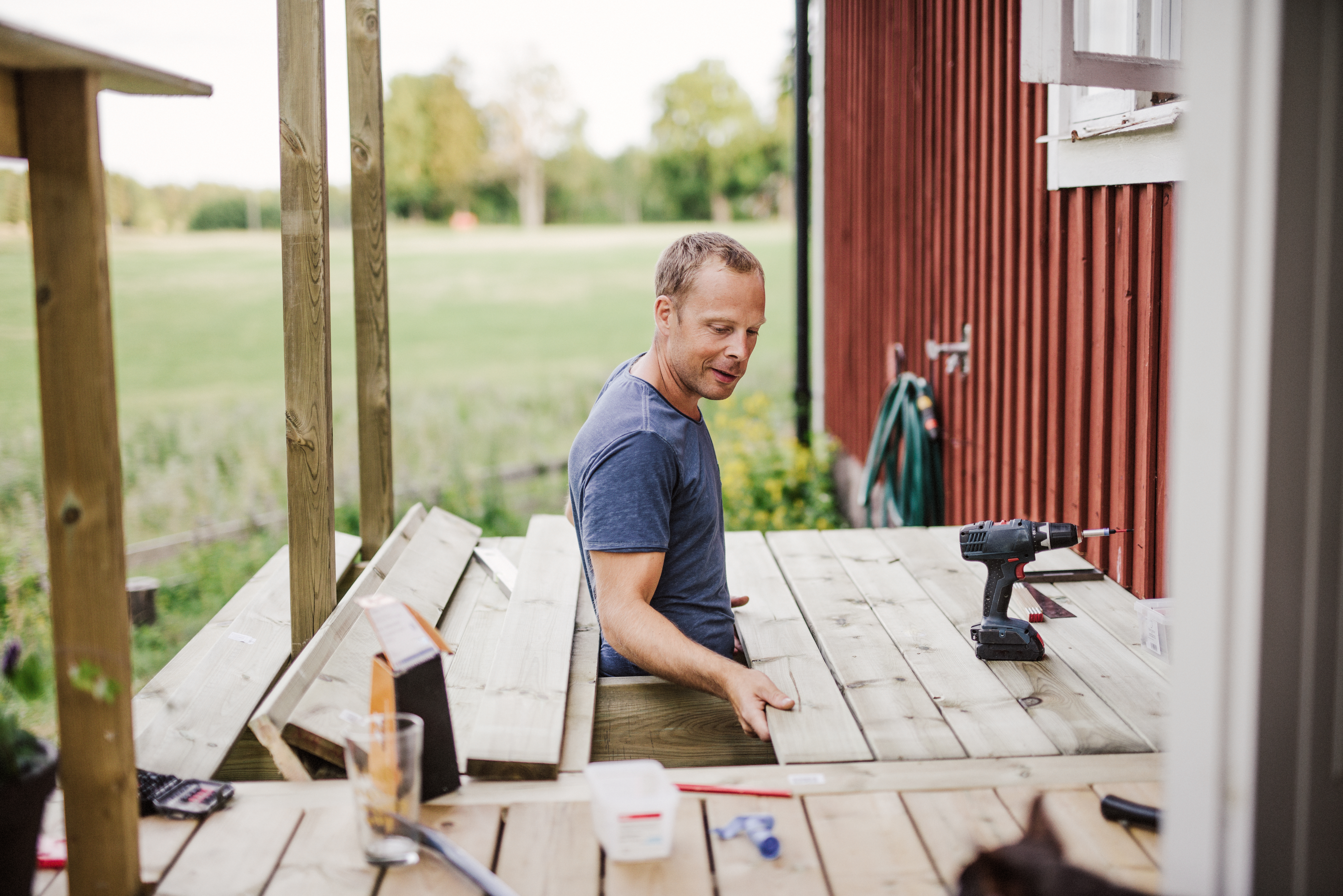 A professional replacing a wooden board on a deck