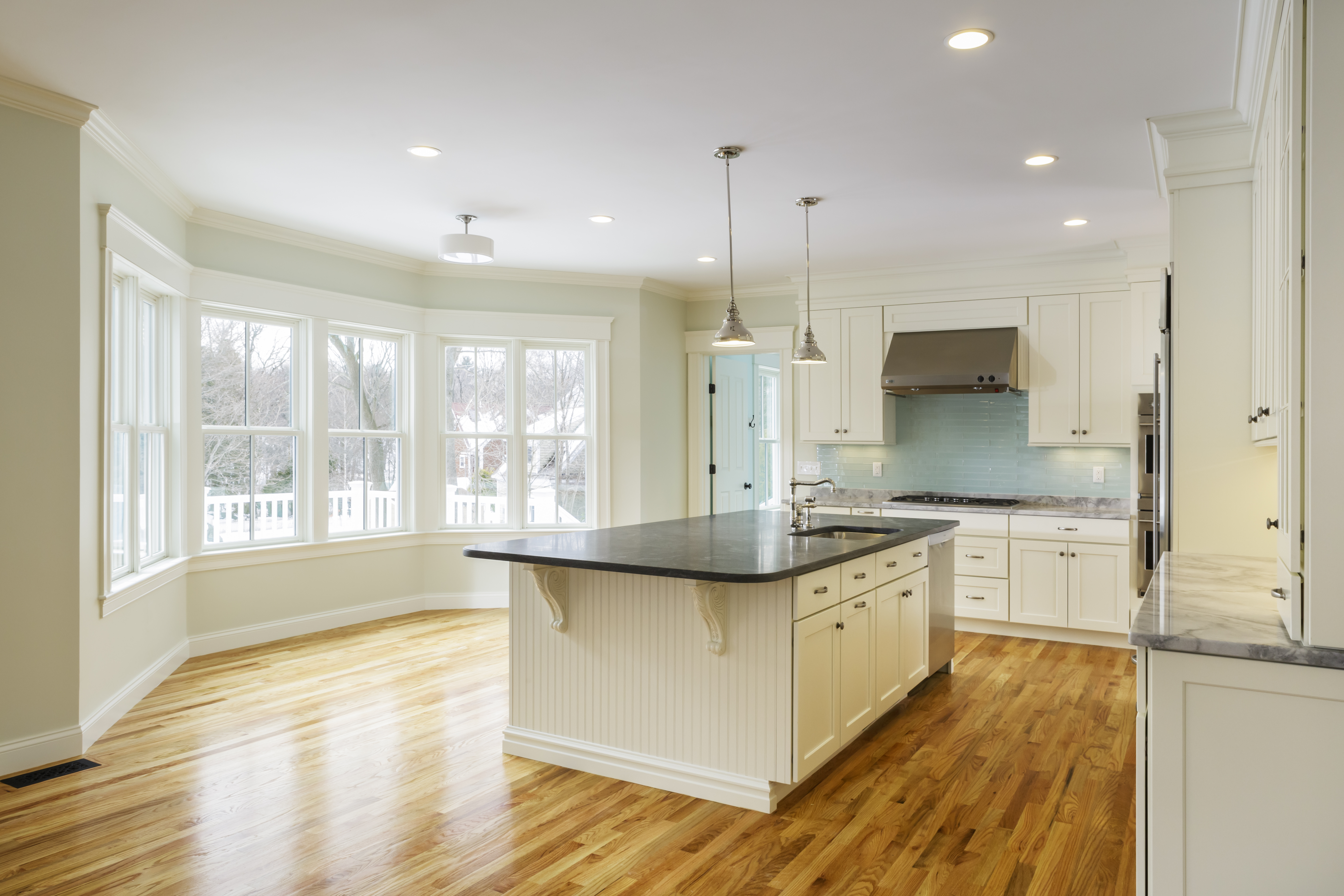 A spacious kitchen with hardwood floor