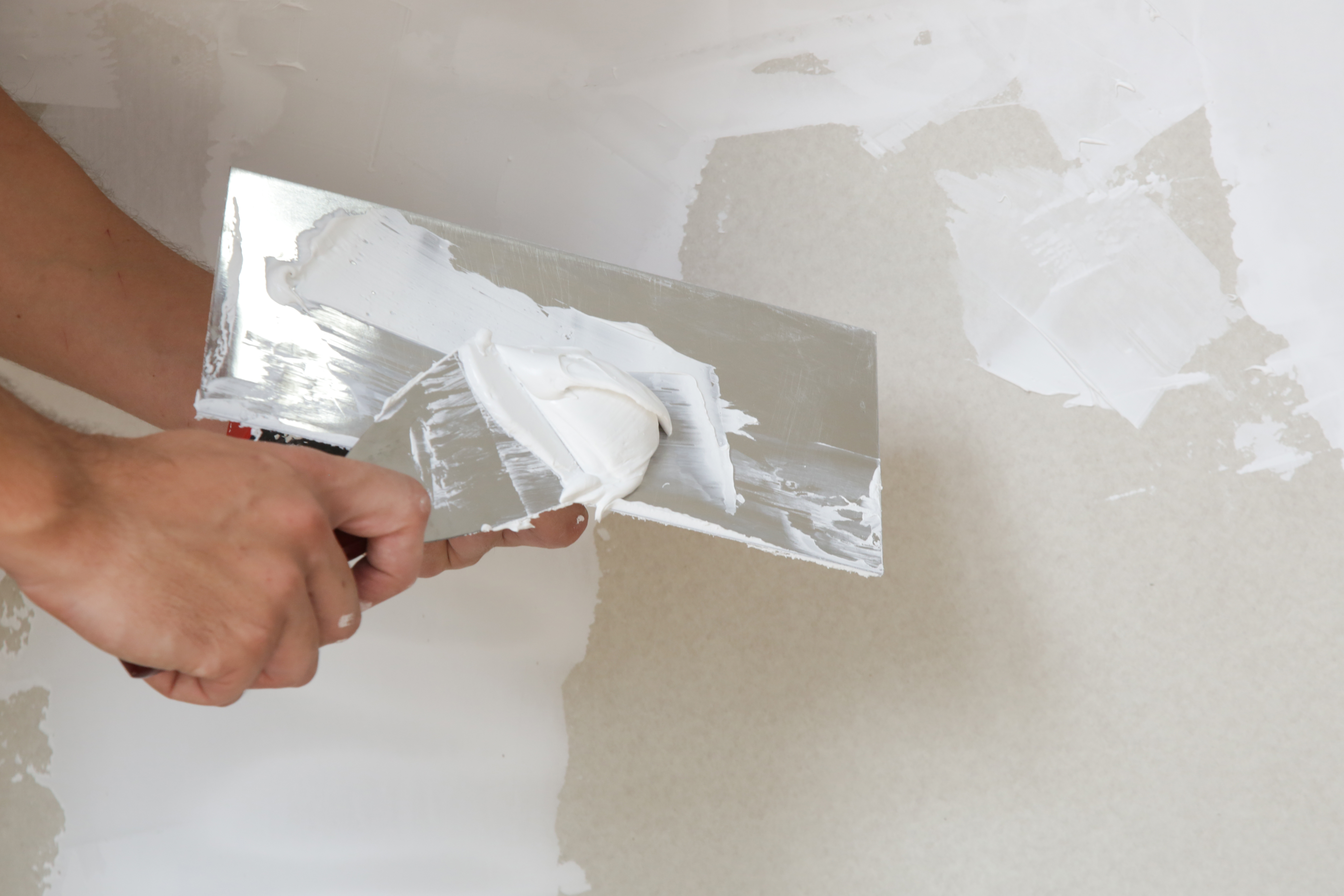 A person plastering a wall