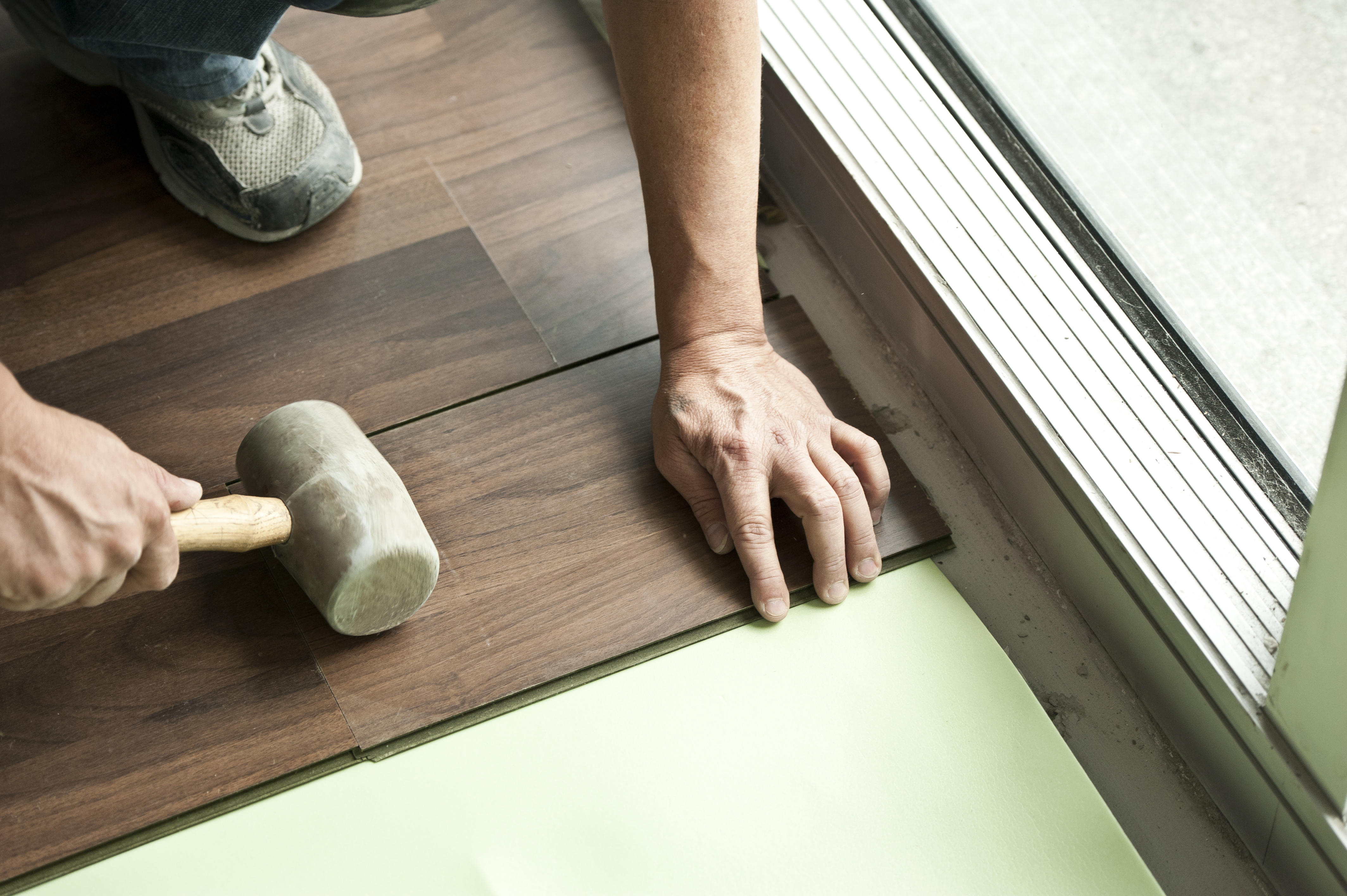 Man holding installing vinyl  floor