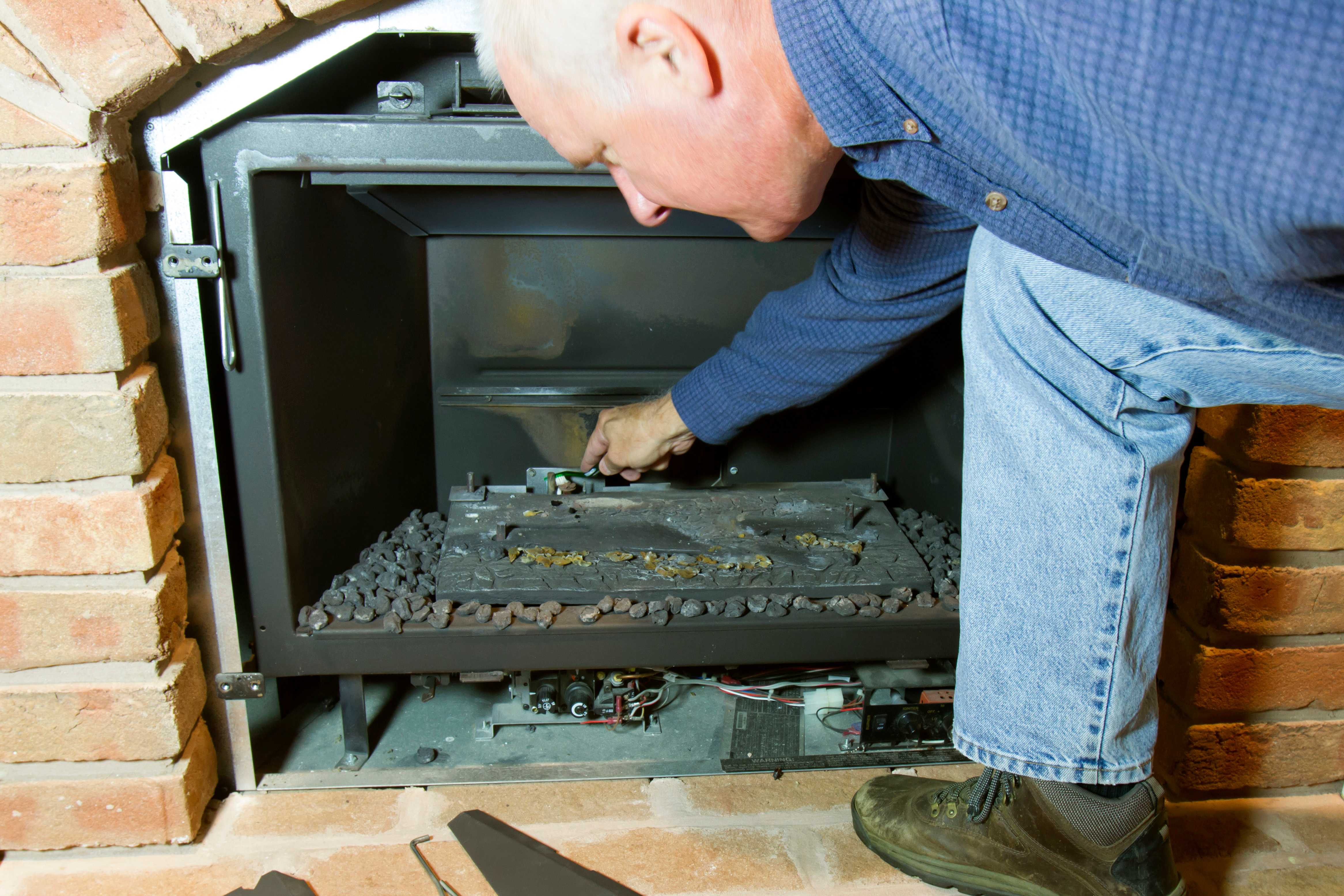 Worker checking out gas fireplace  