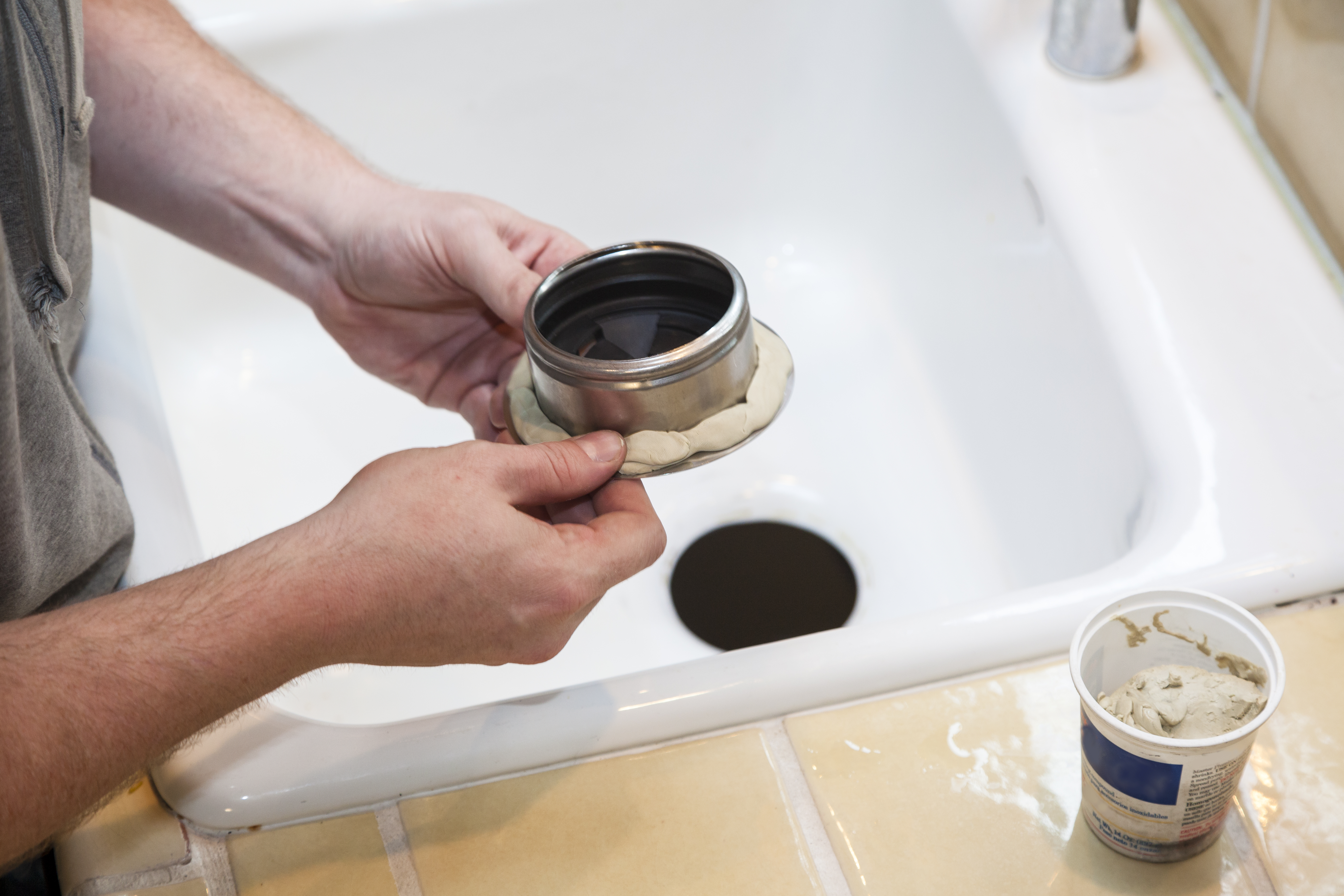 Man installing garbage disposal