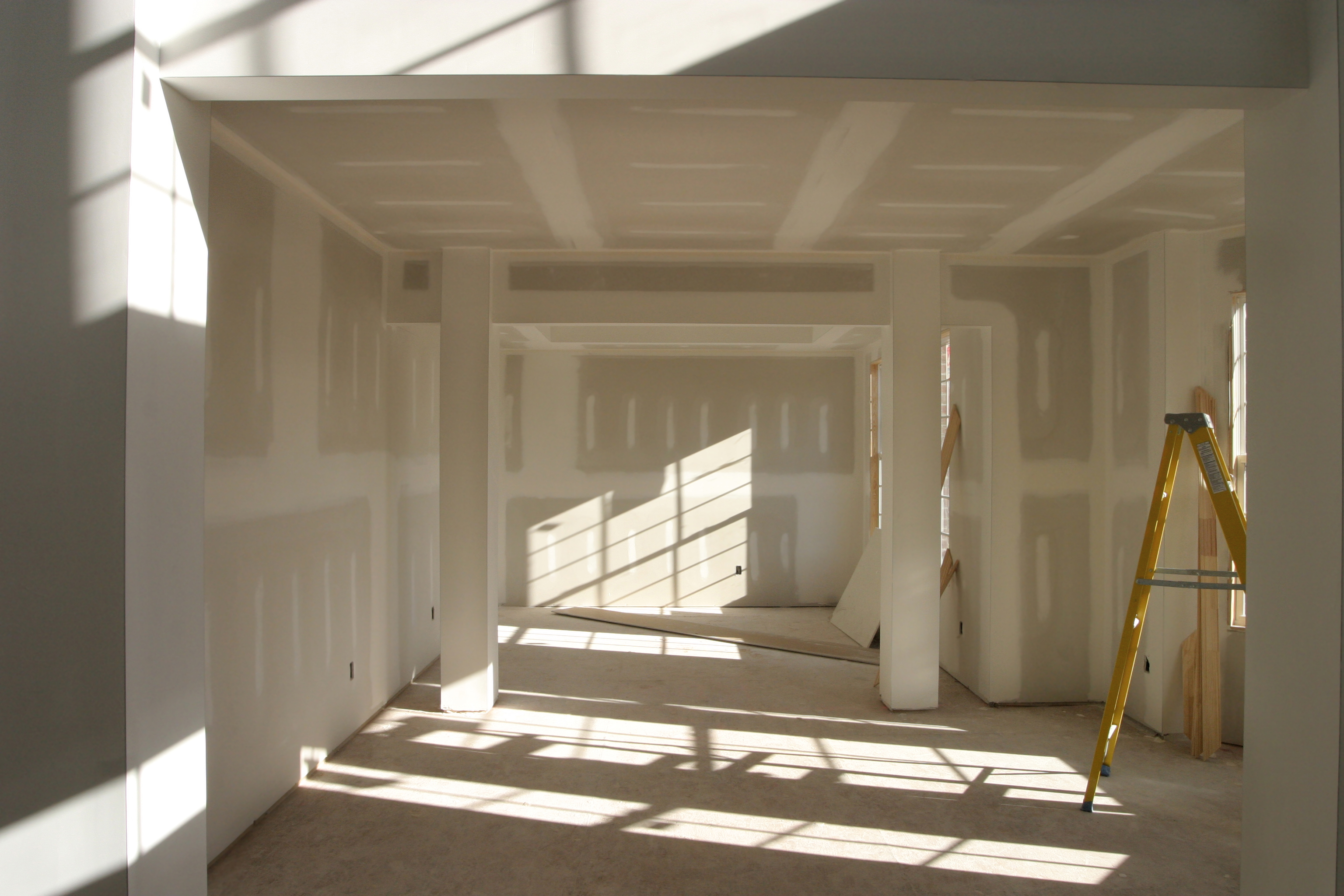 A sunlit drywall room