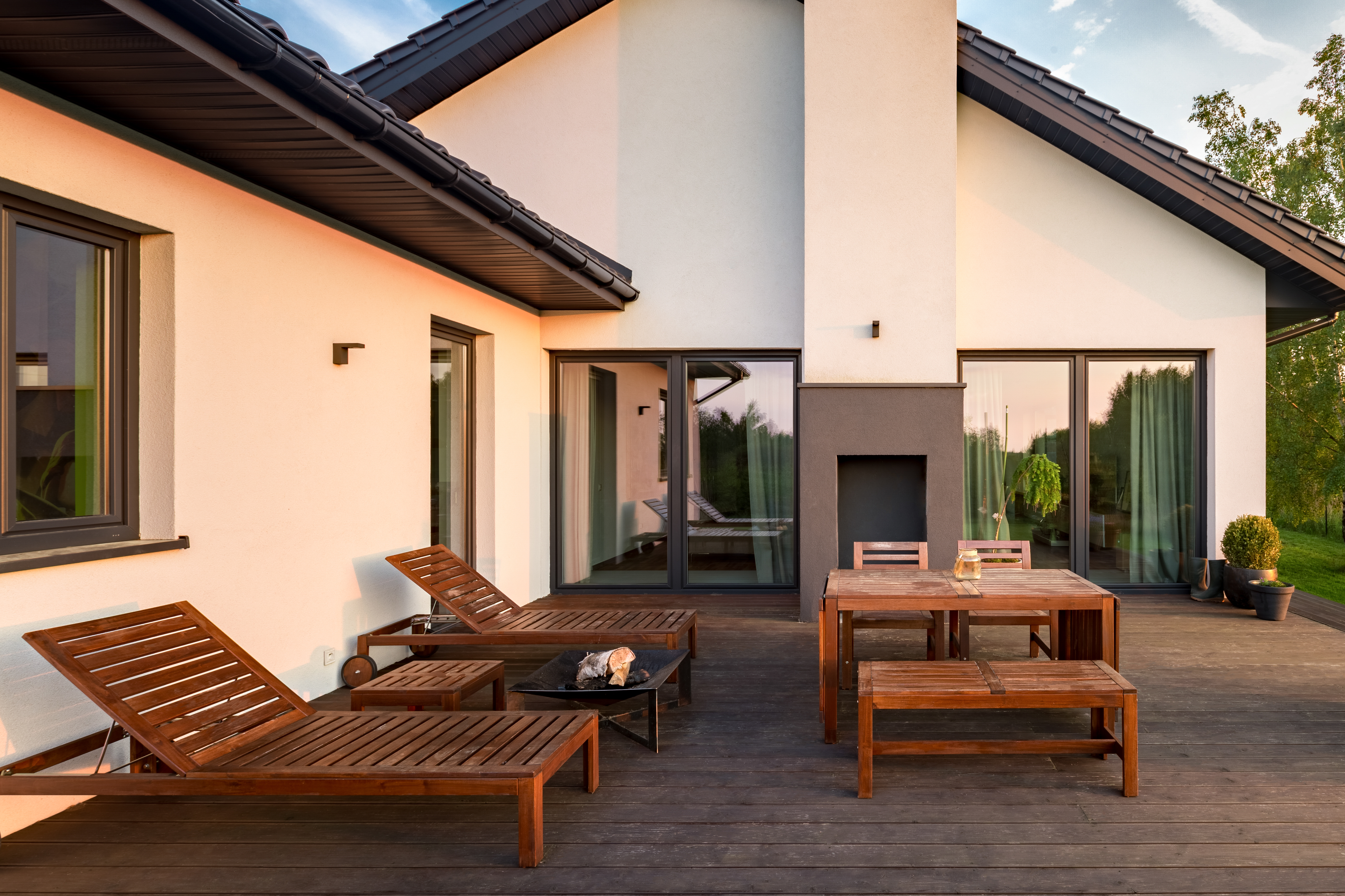 A wooden deck in the backyard of a house