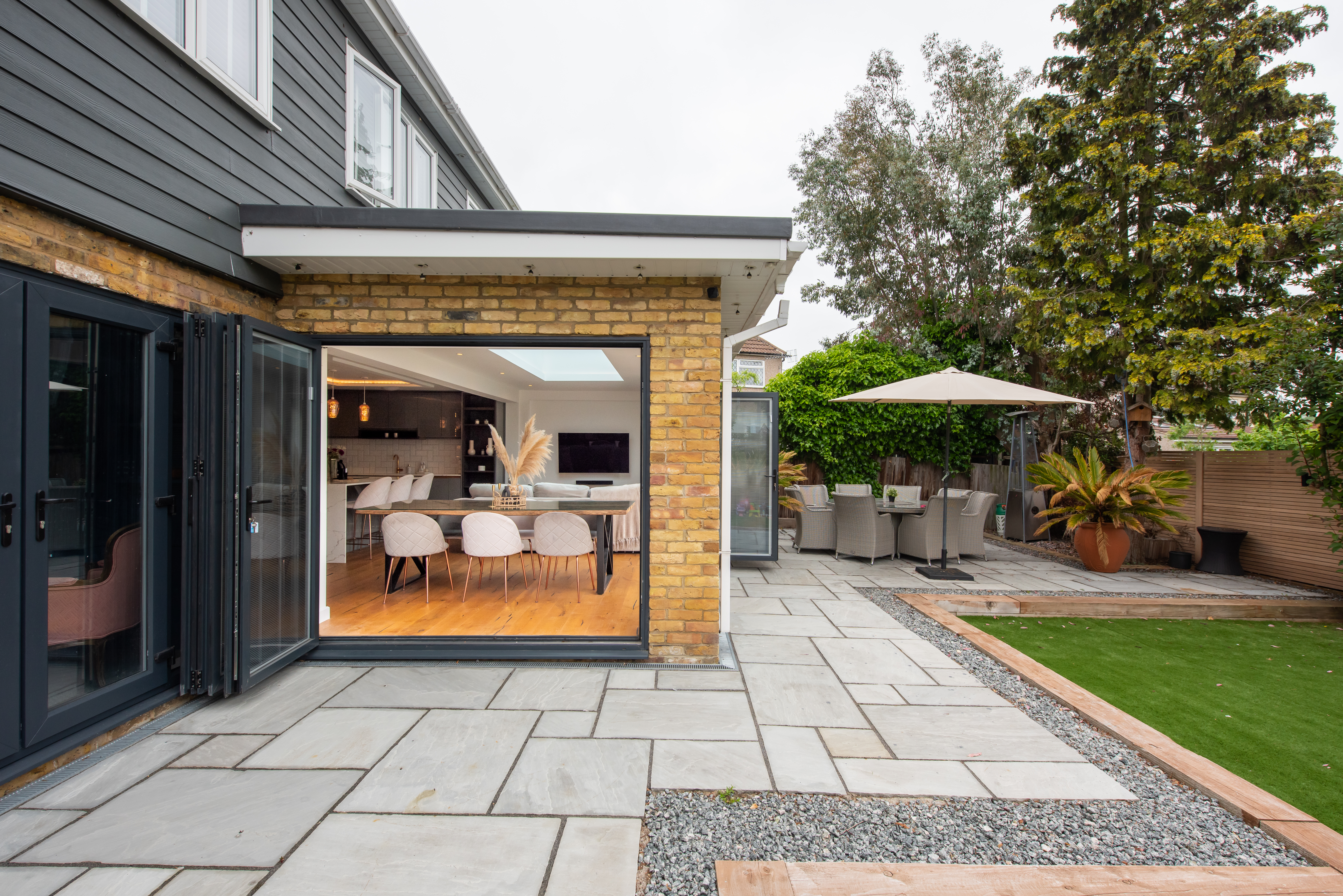 A backyard of a house with pavers