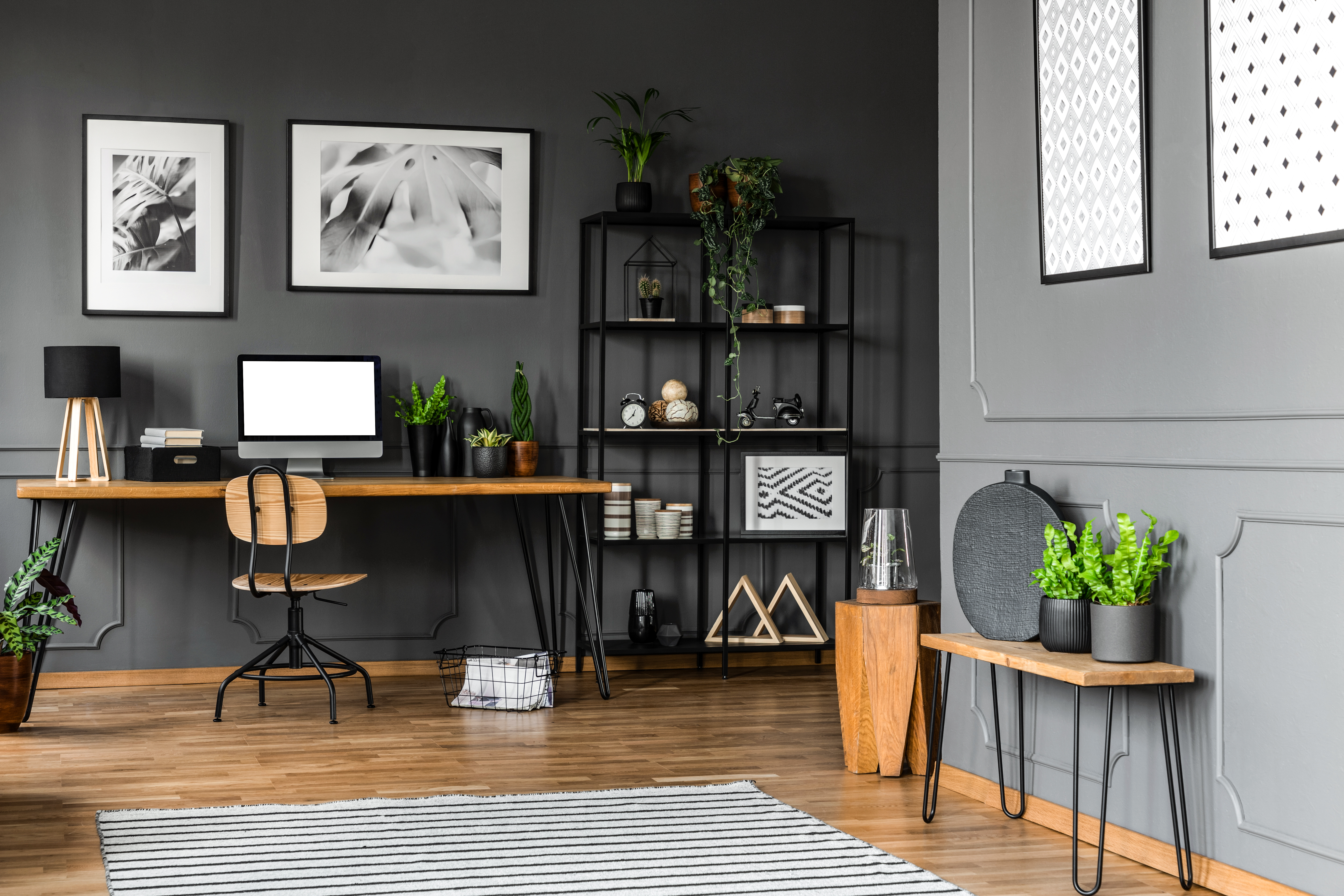 Stylish home office with wood baseboard and gray walls