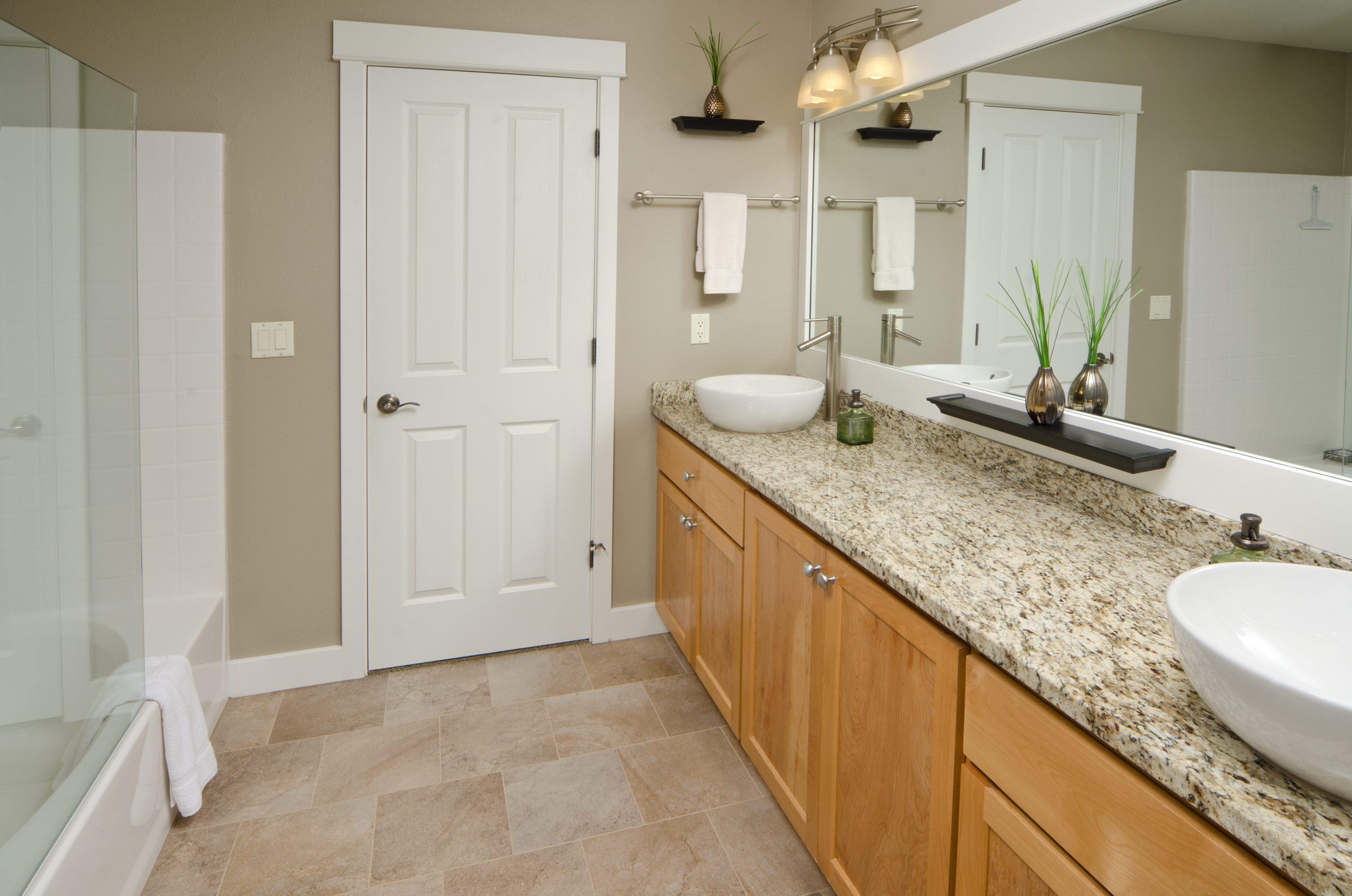 White PVC baseboard installed in a bathroom with beige walls