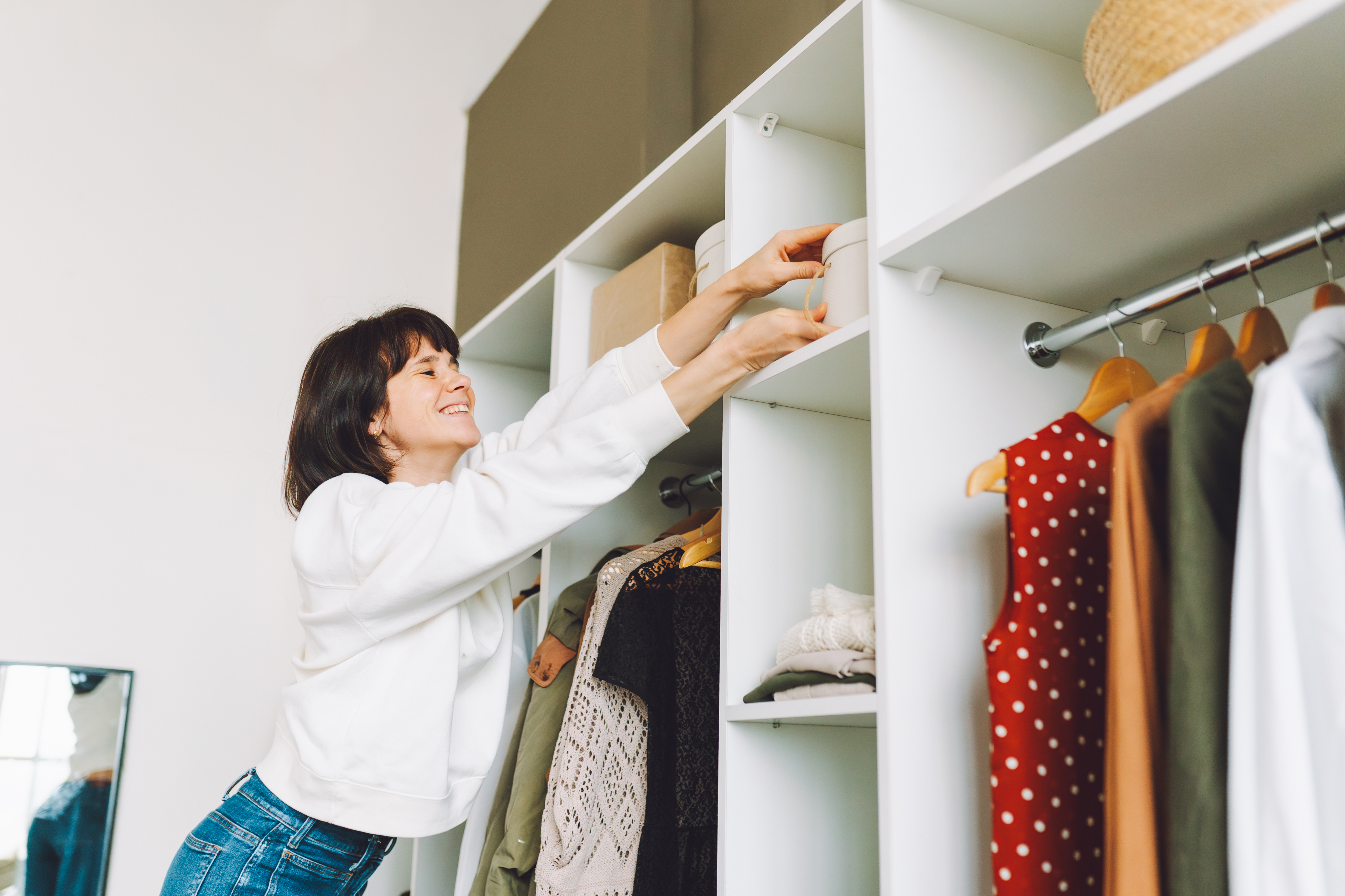 Woman cleaning up her closet