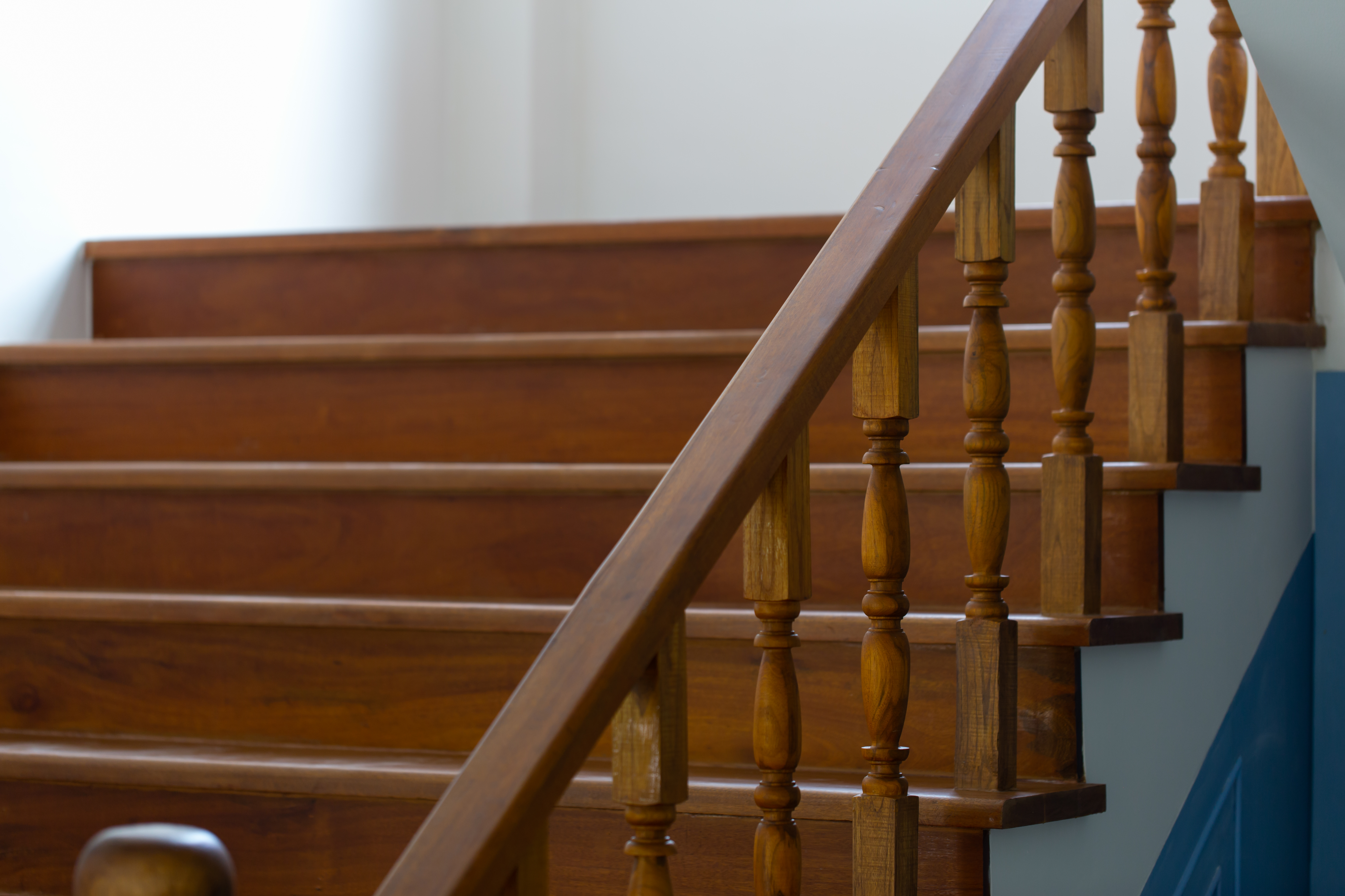 wooden staircase with a polished handrail