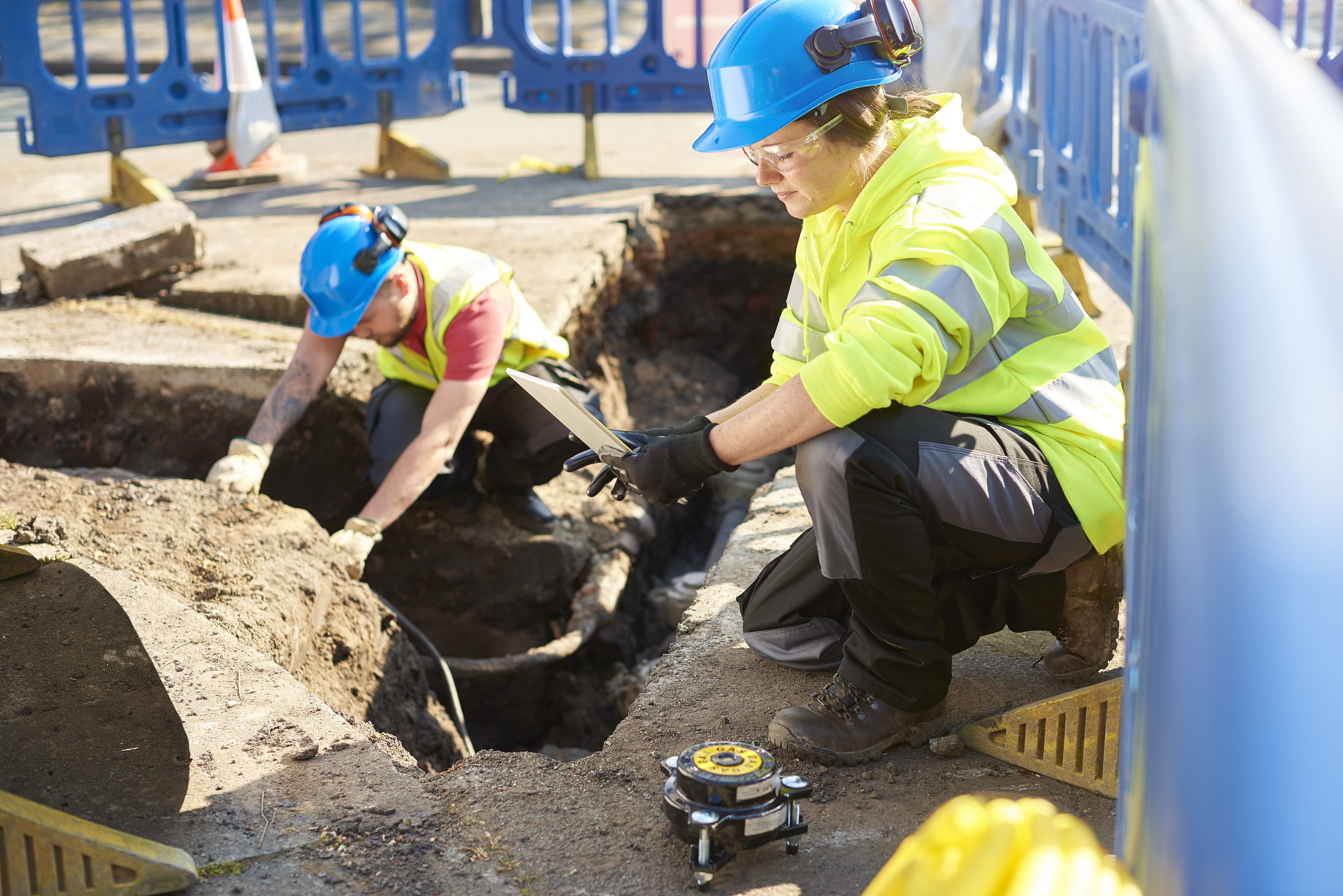 Inspector supervising a new excavation in the city