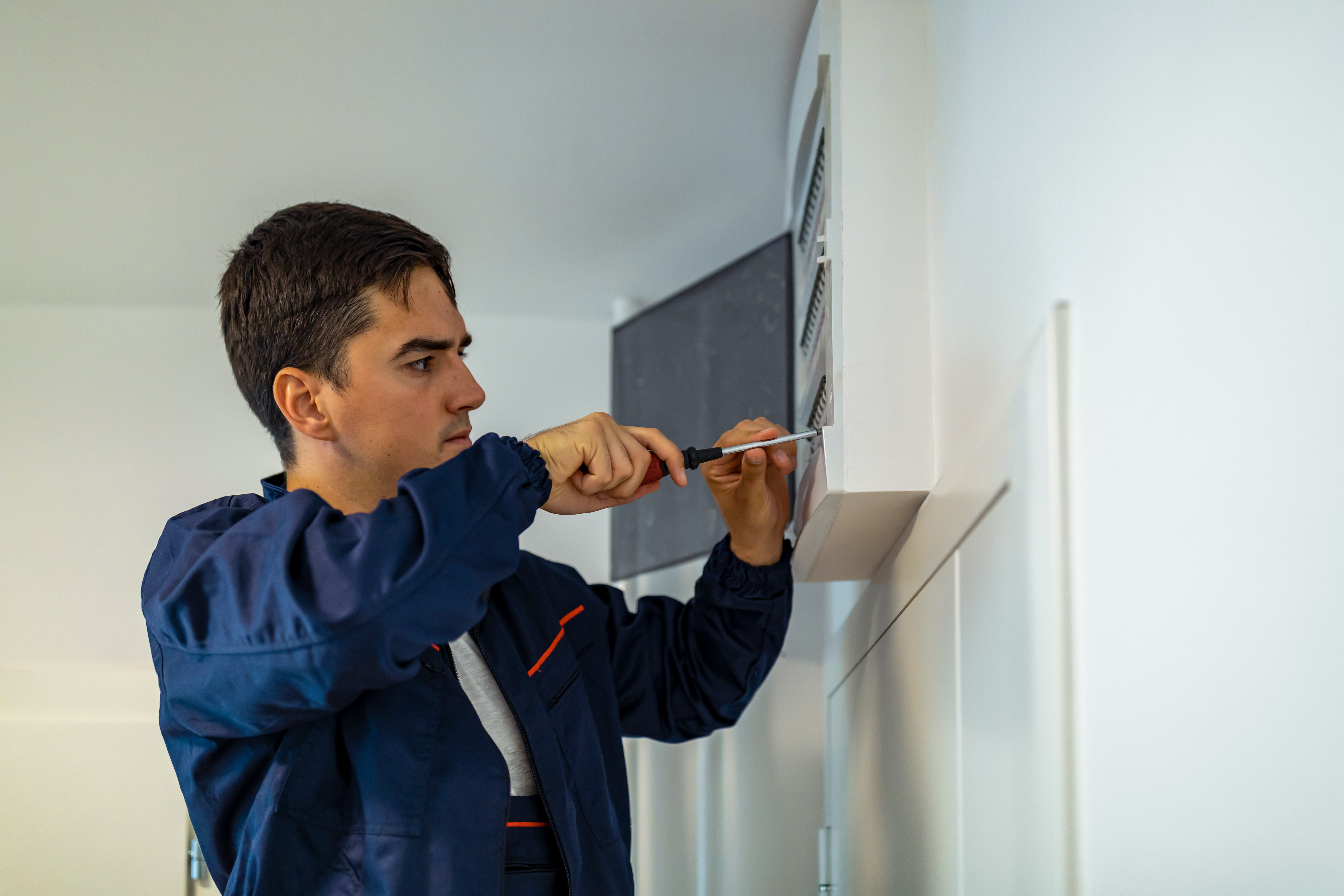 man replacing electrical box