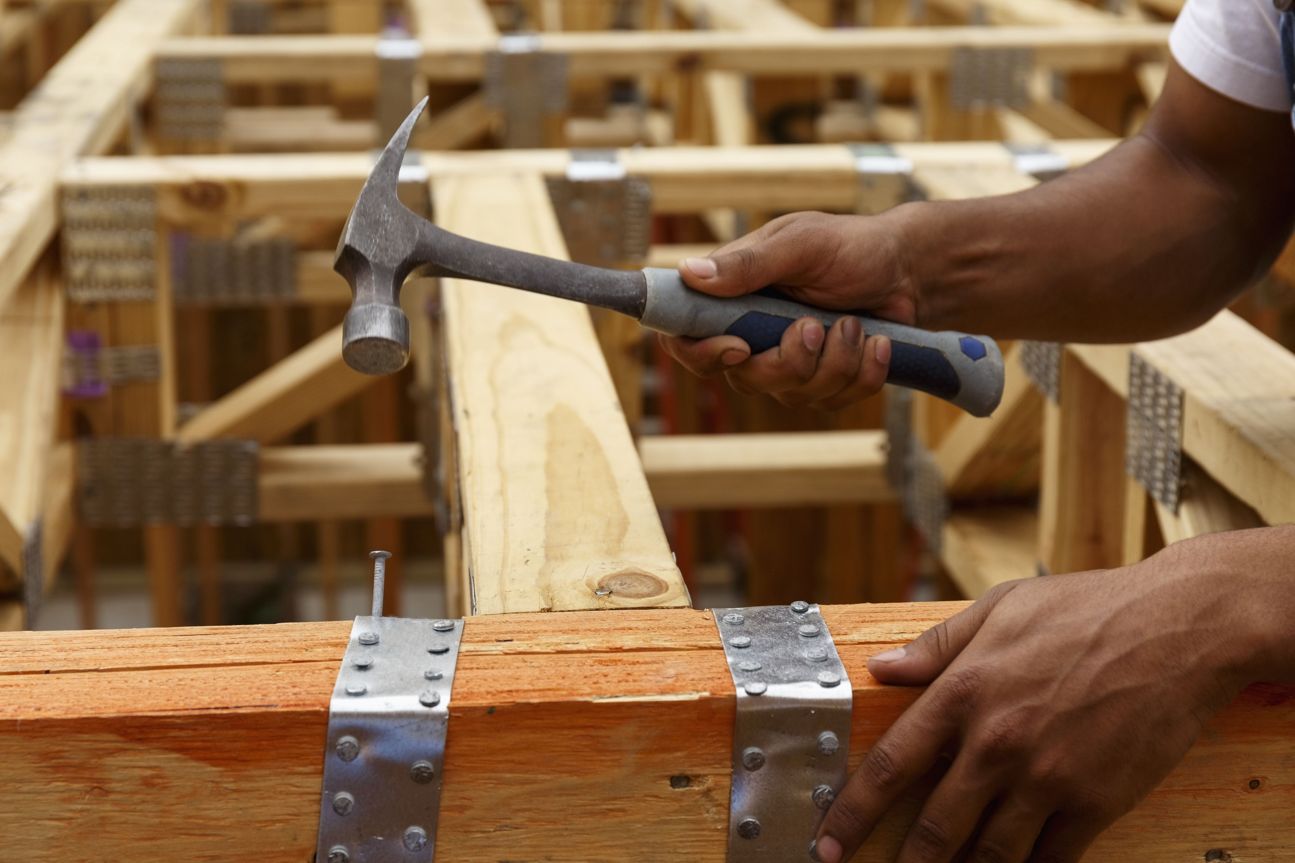 Man nailing wood flooring.