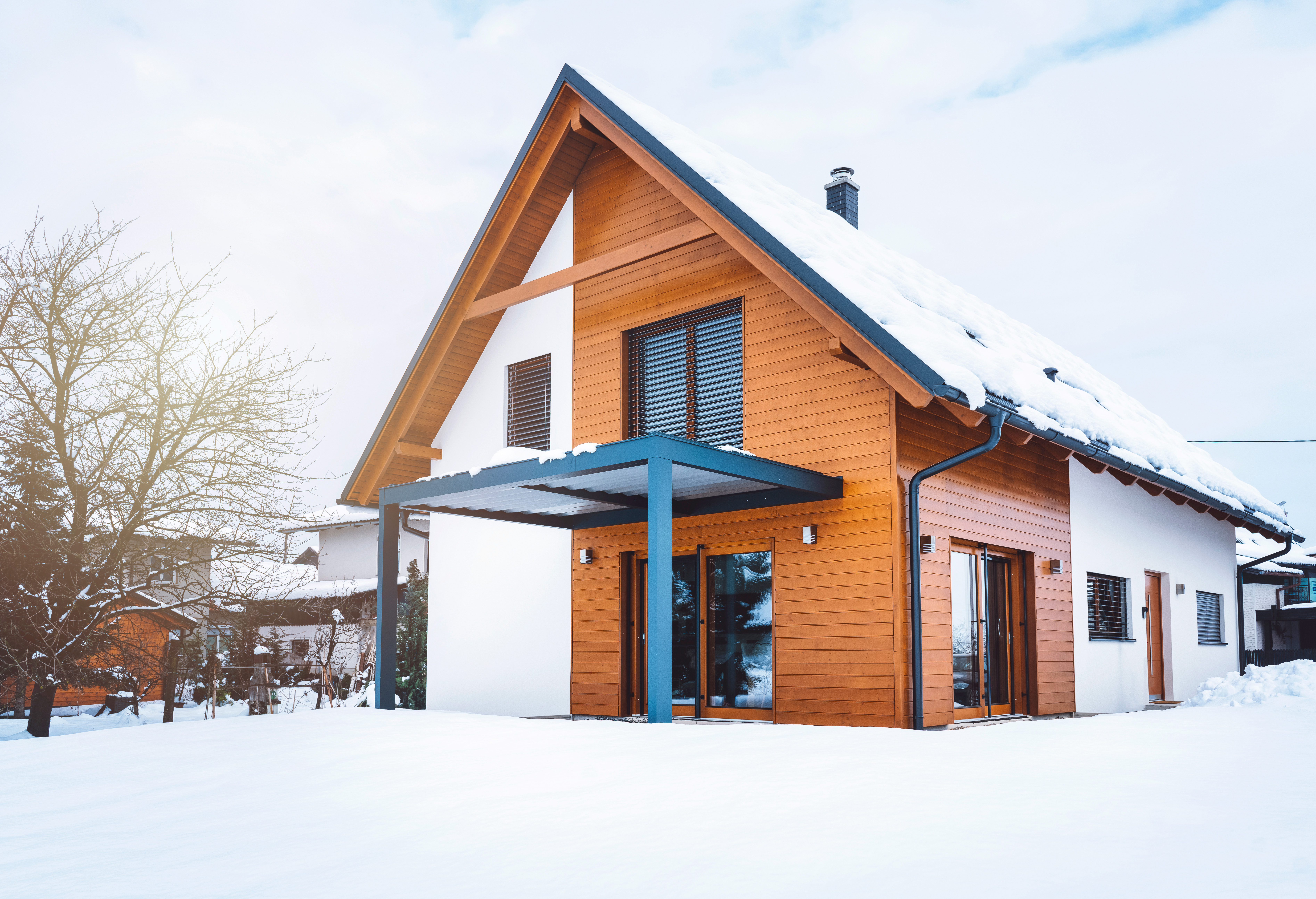 Modern house with a metal roof covered with snow 